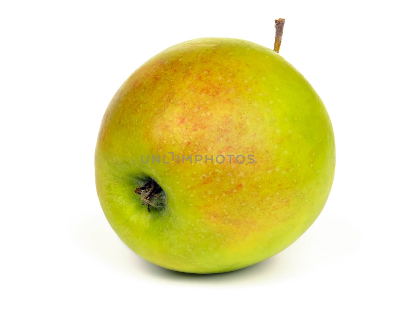 Ripe green apple with red spots isolated on white background.