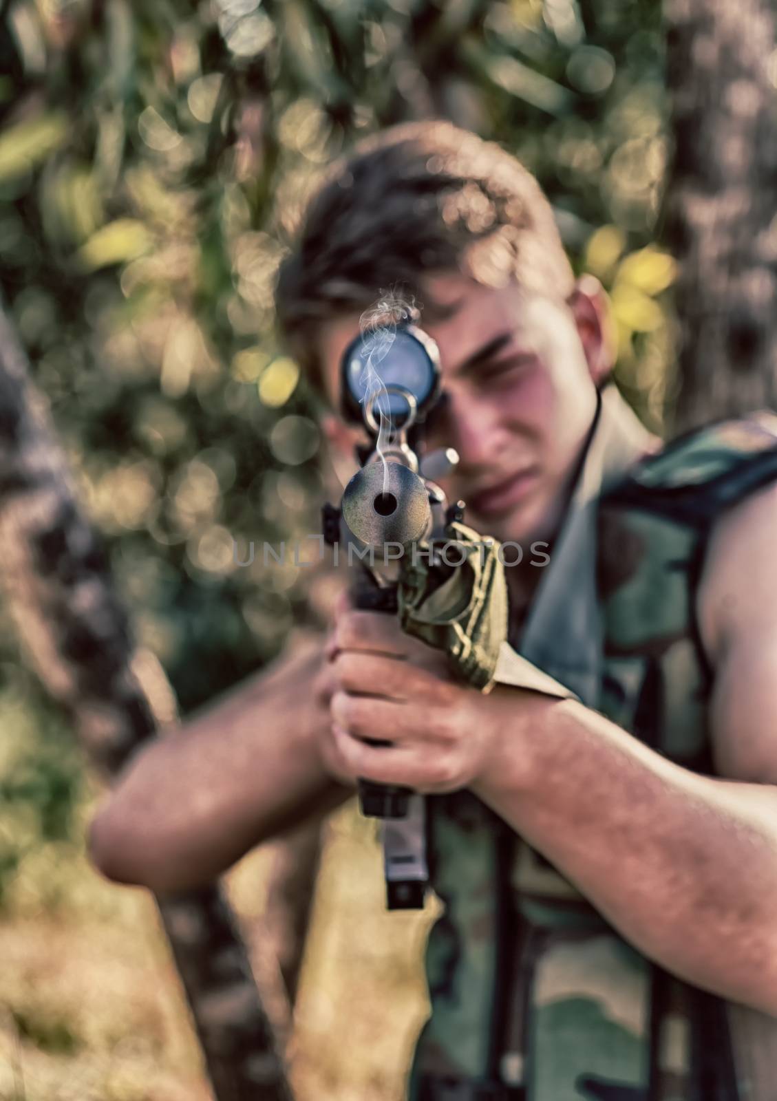 young a soldier in the uniform with weapon