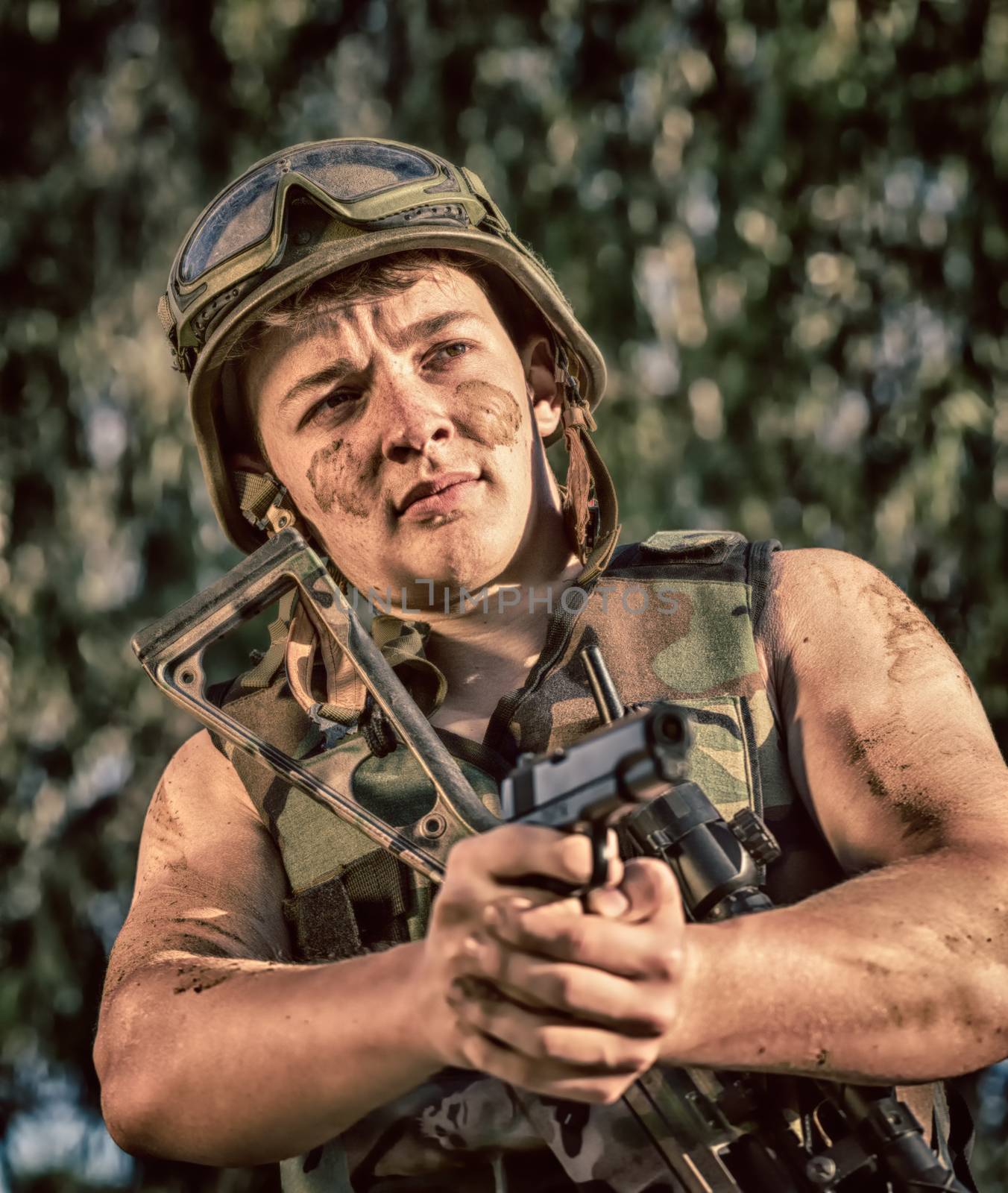 young a soldier in the uniform with weapon