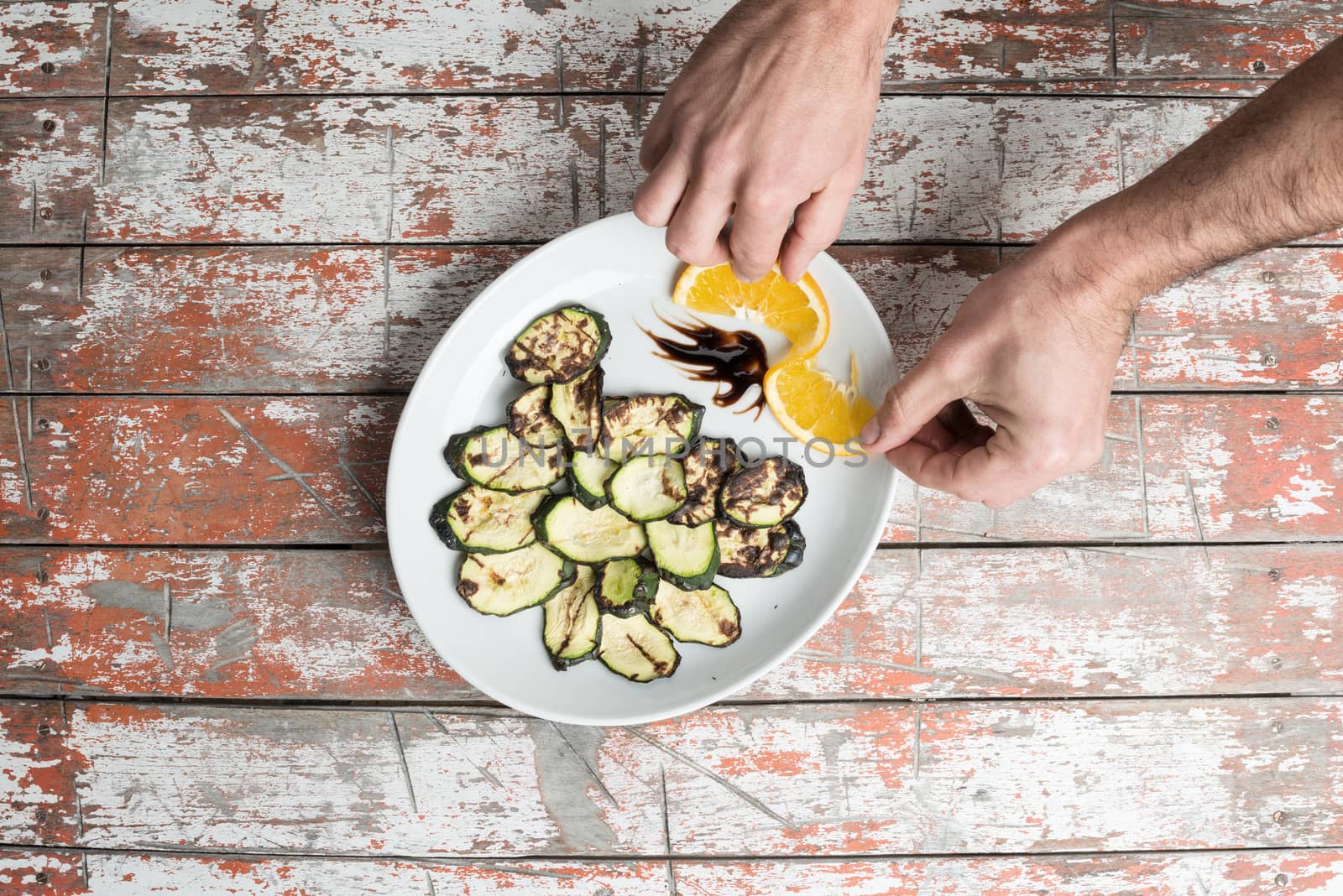 vegan grilled zucchini on dish with orange