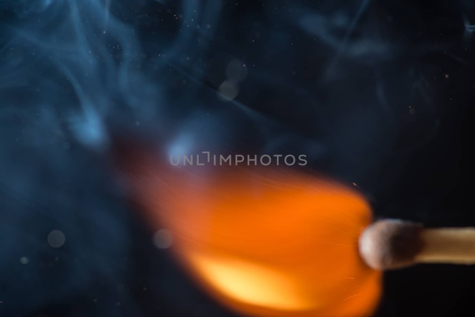 Match with smoke and fire on black background  copyspace by skrotov