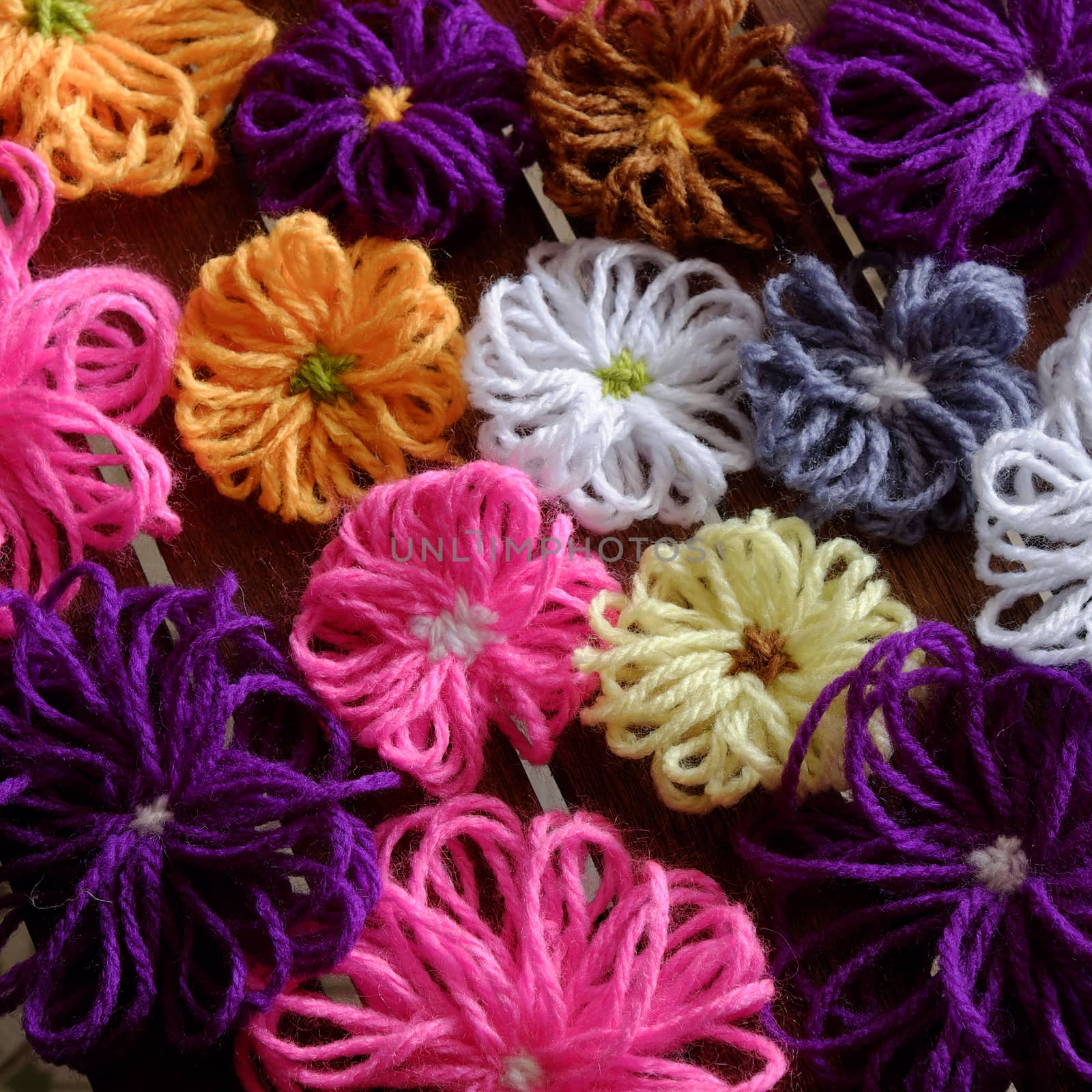 Group of handmade craft for mother day, colorful daisy flower on wood background, ornament make from yarn