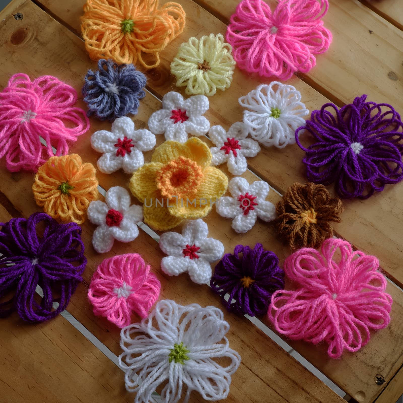 Group of handmade craft for mother day, colorful daisy flower on wood background, ornament make from yarn