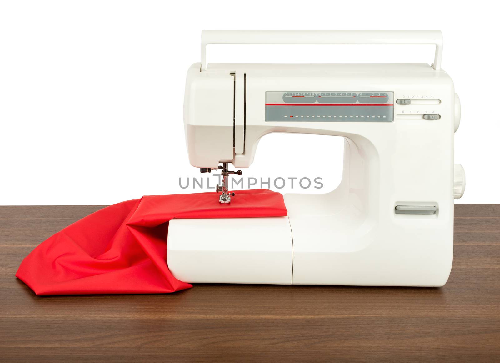 Sewing machine and red fabric isolated on white background