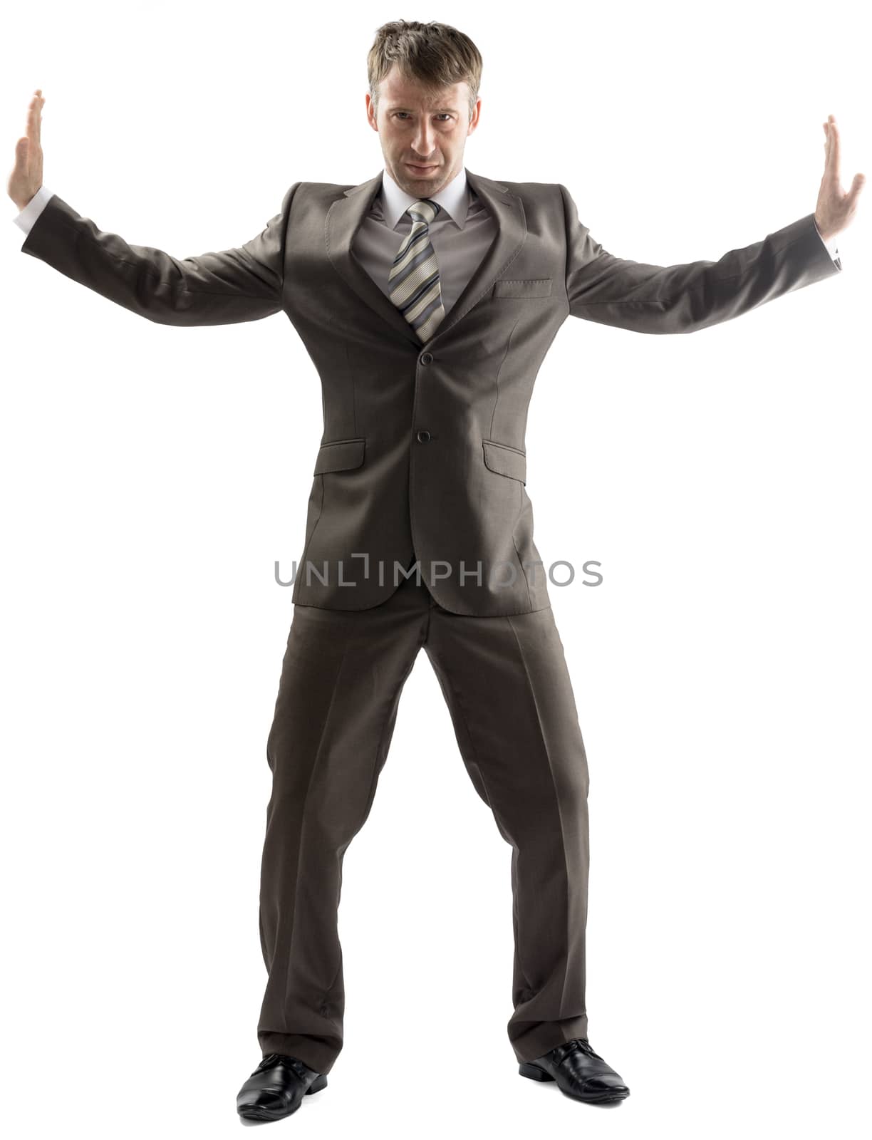 Business man stretching his arms to sides isolated on white background