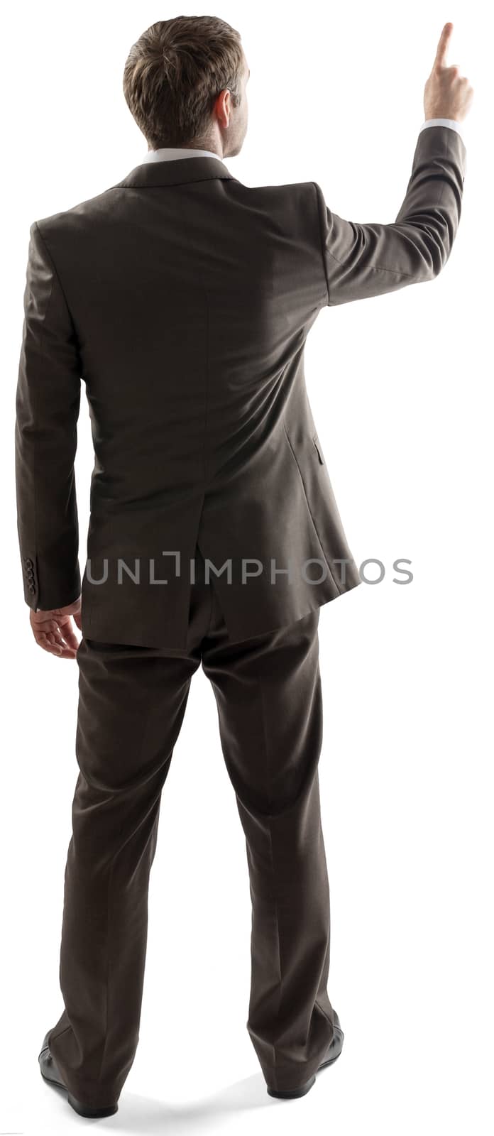 Rear view of young business man pointing at copy space isolated over white background. Full length portrait of businessman standing back