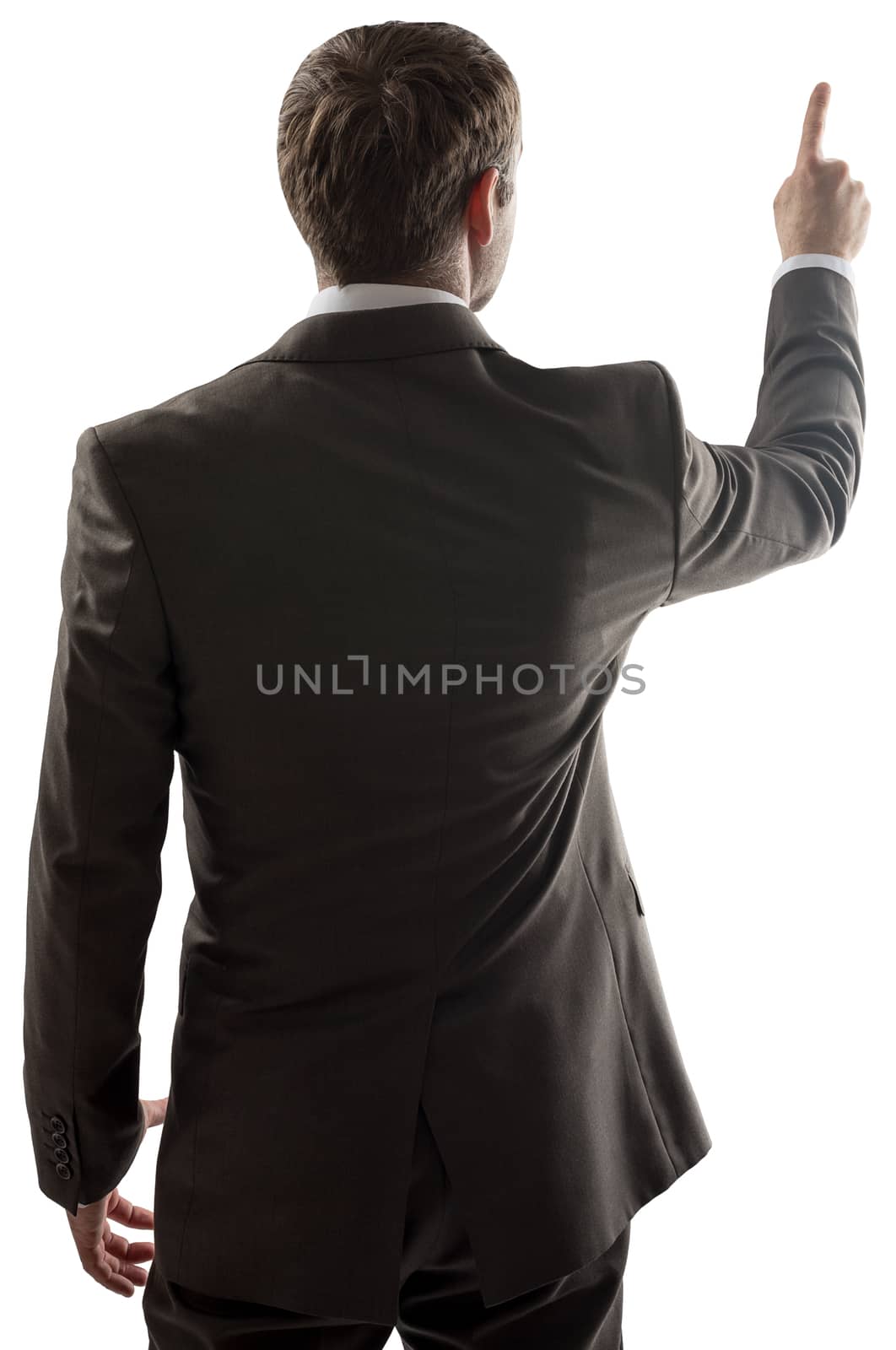 Rear view of young business man pointing at copy space isolated over white background. Portrait of businessman standing back