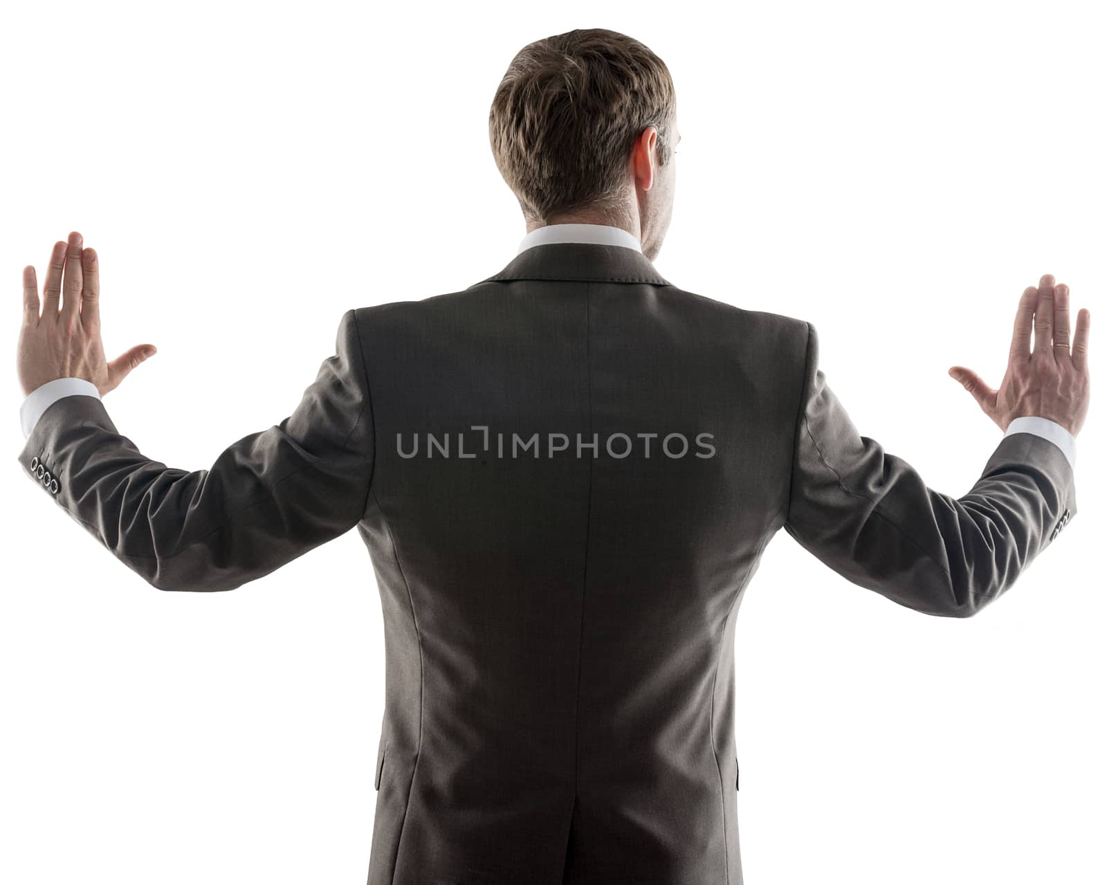 Rear view of young business man pointing at copy space isolated over white background, portrait of businessman standing back