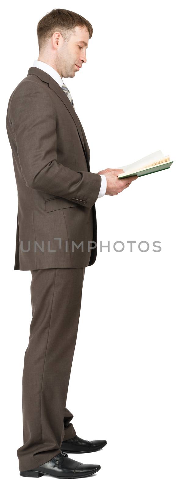 Businessman reading book isolated on white background, side view