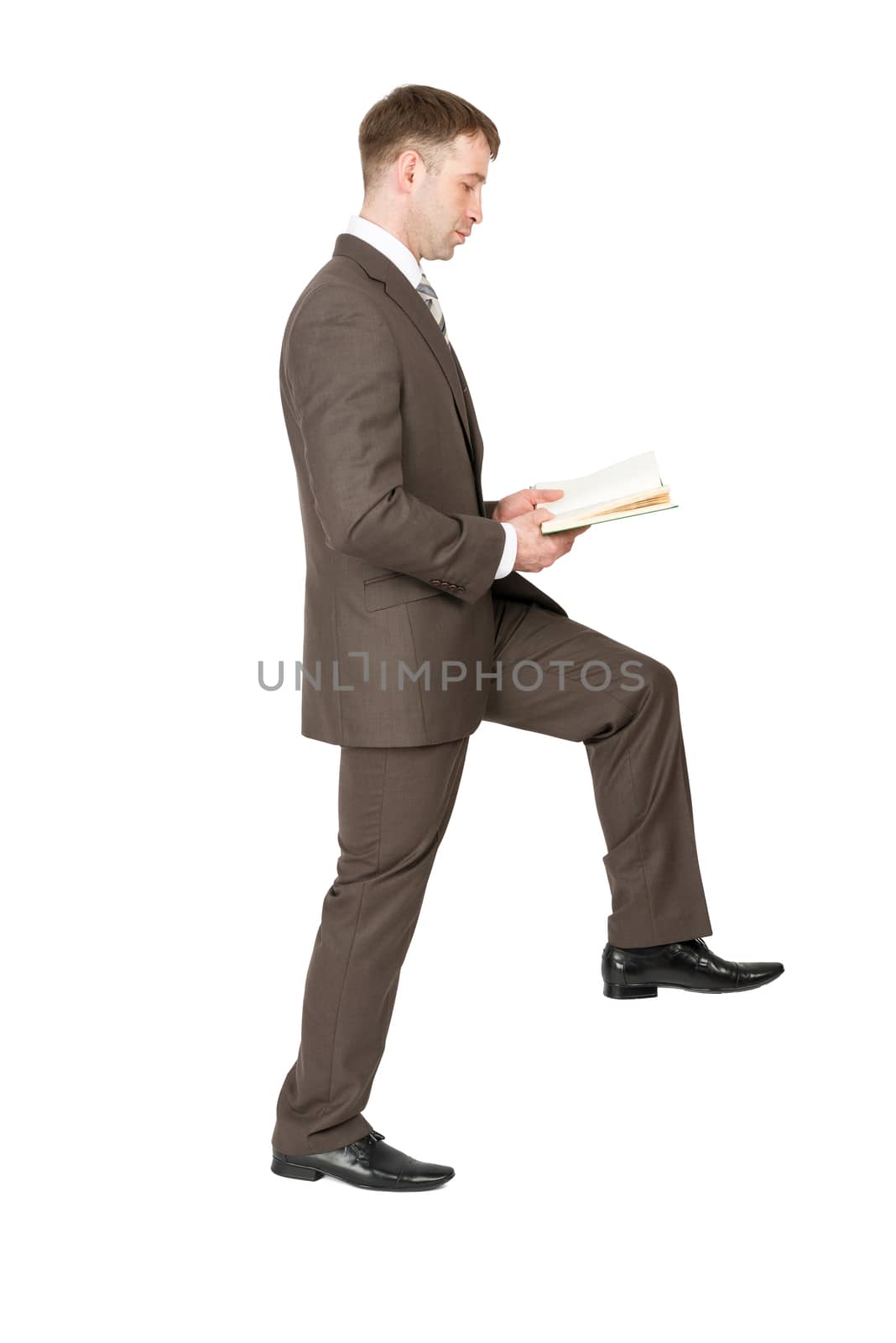 Businessman reading book while walking isolated on white background