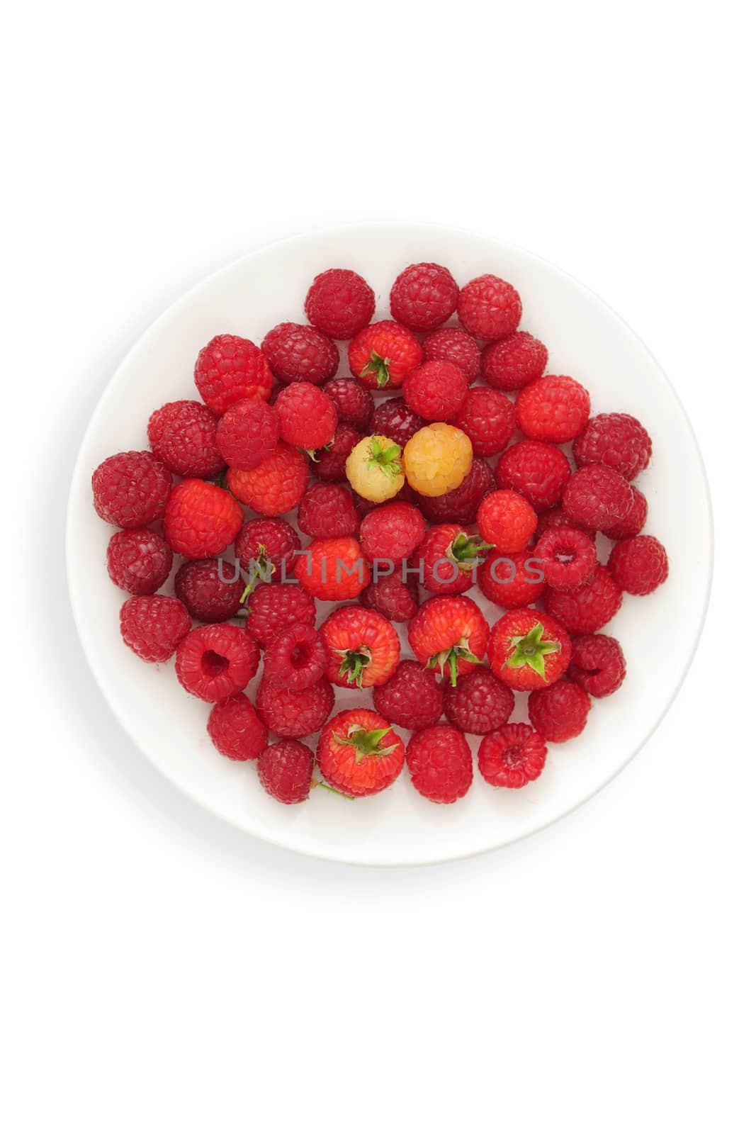 Ripe berries of a raspberry on a plate - white background by cococinema