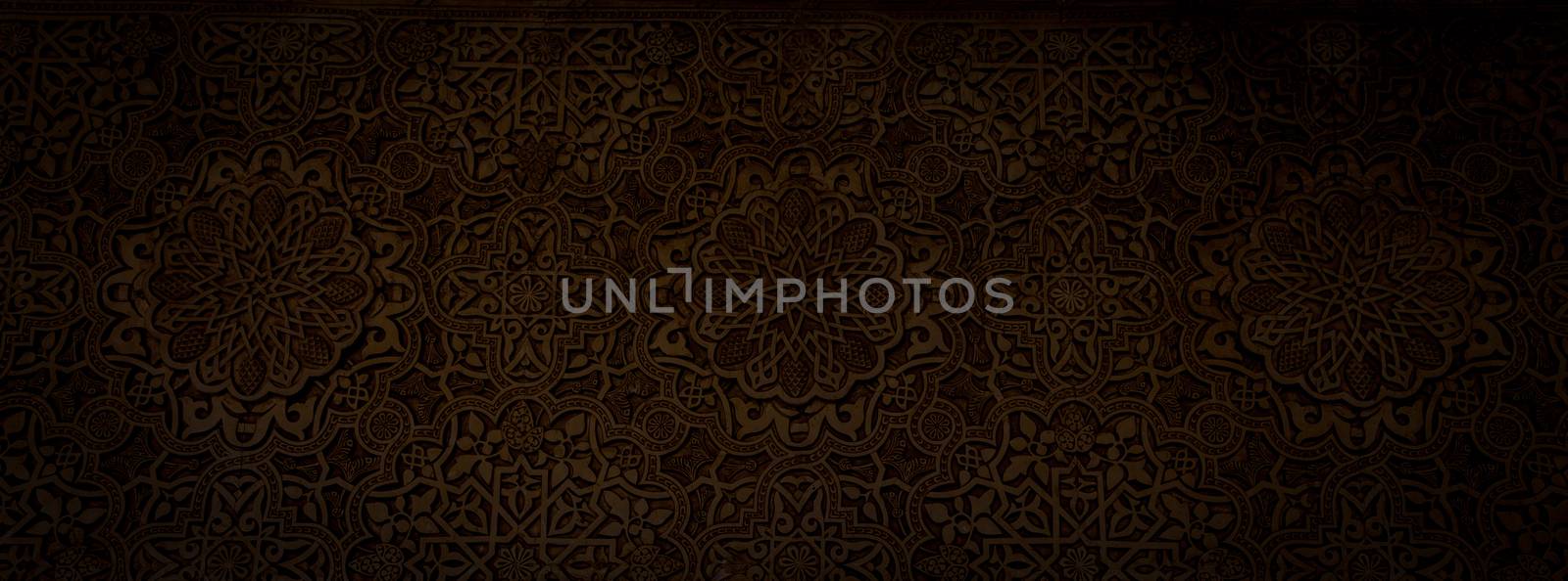 Wall detail of Alhambra UNESCO site in Granada - South of Spain. 600 years old arabic characters.