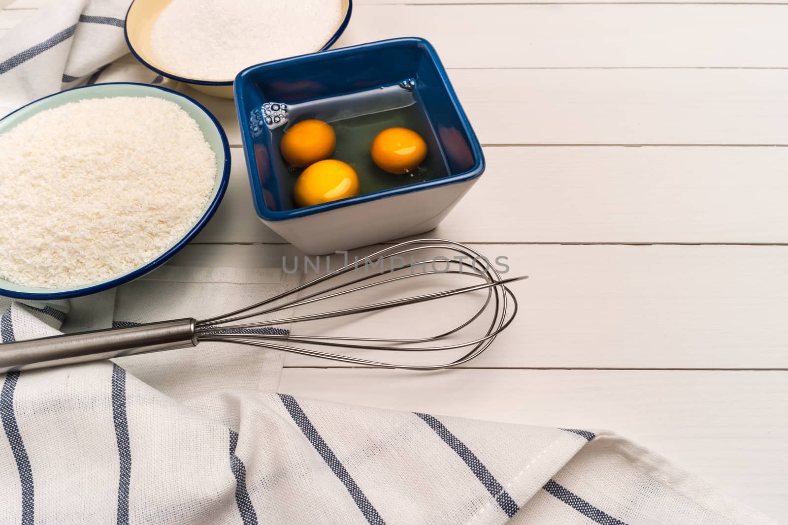 Ingredients for baking a cookies. Recipe for coconut macaroons.  by AnaMarques