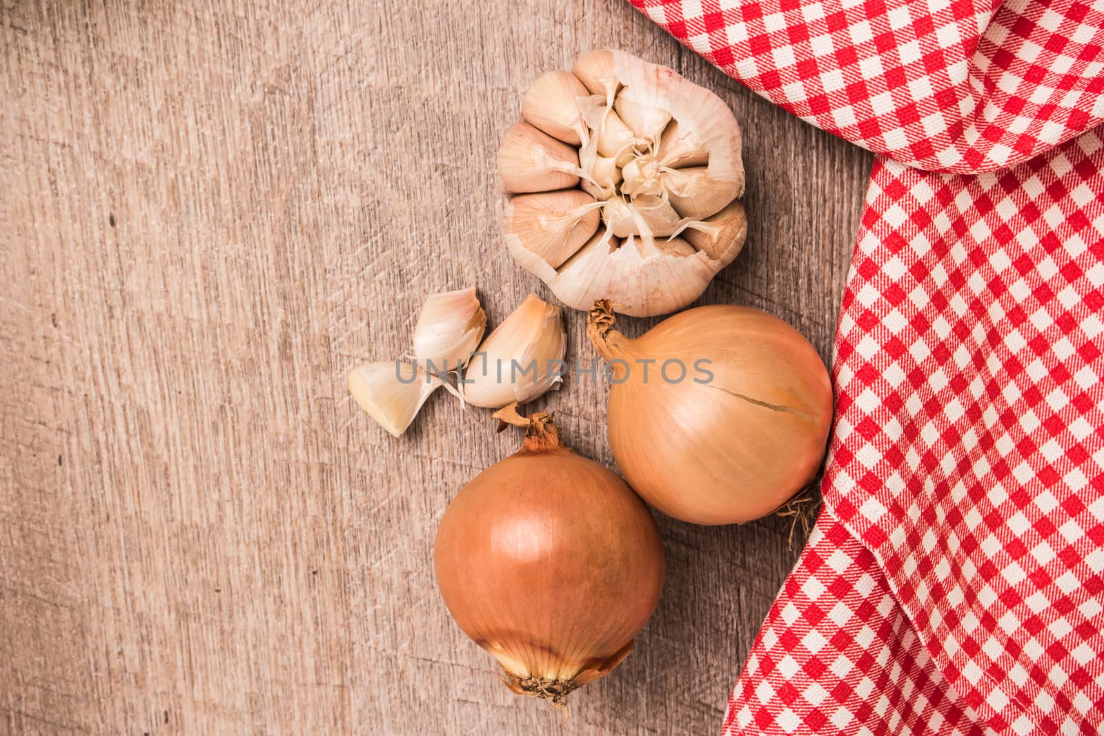 Fresh vegetables from the garden, garlic and onions on a wooden  by AnaMarques