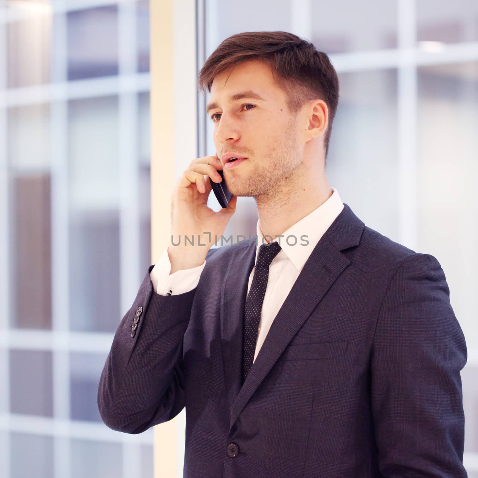 Businessman talking on phone by ALotOfPeople