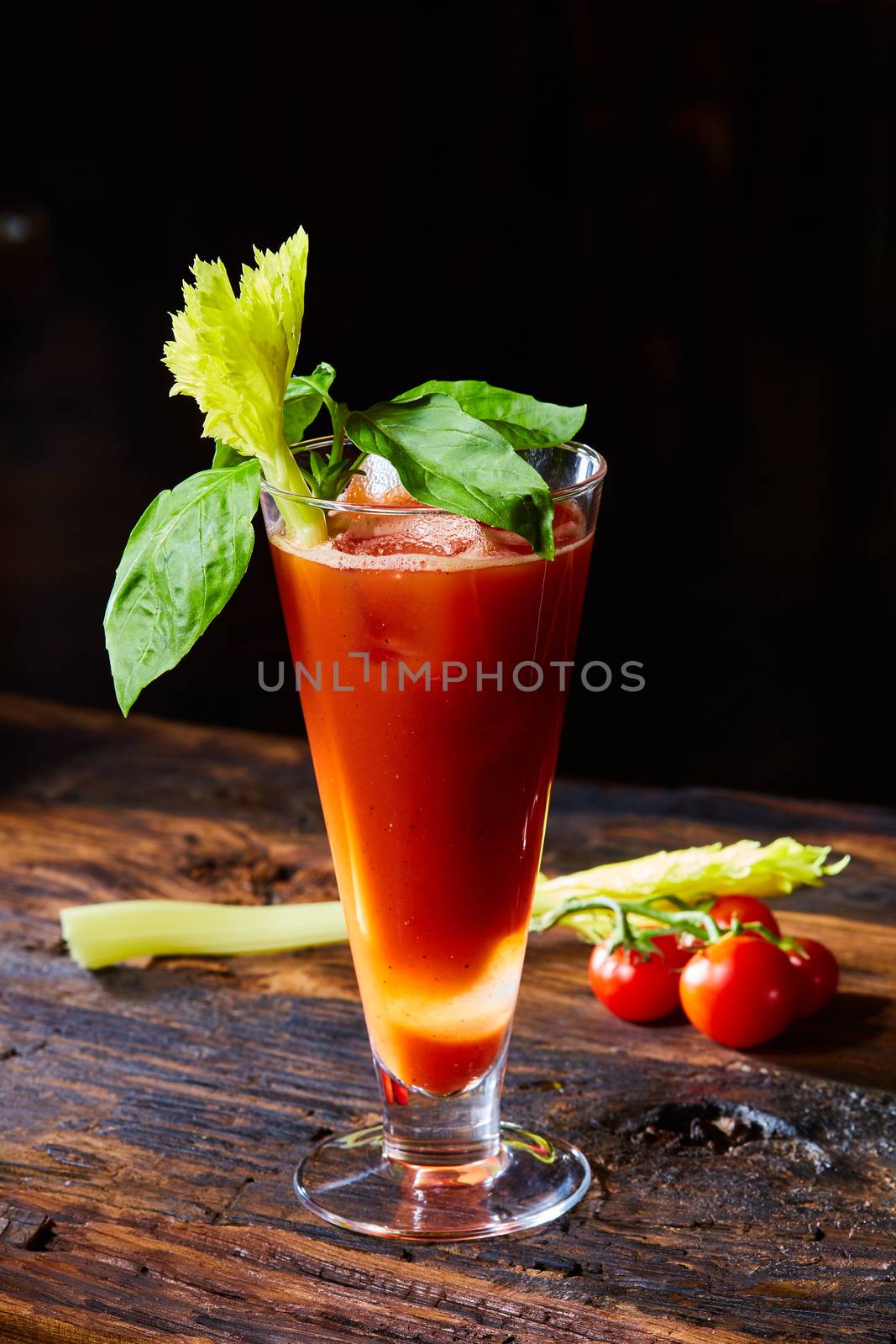 Cocktail Bloody Mary with ice in glasses on a wooden table