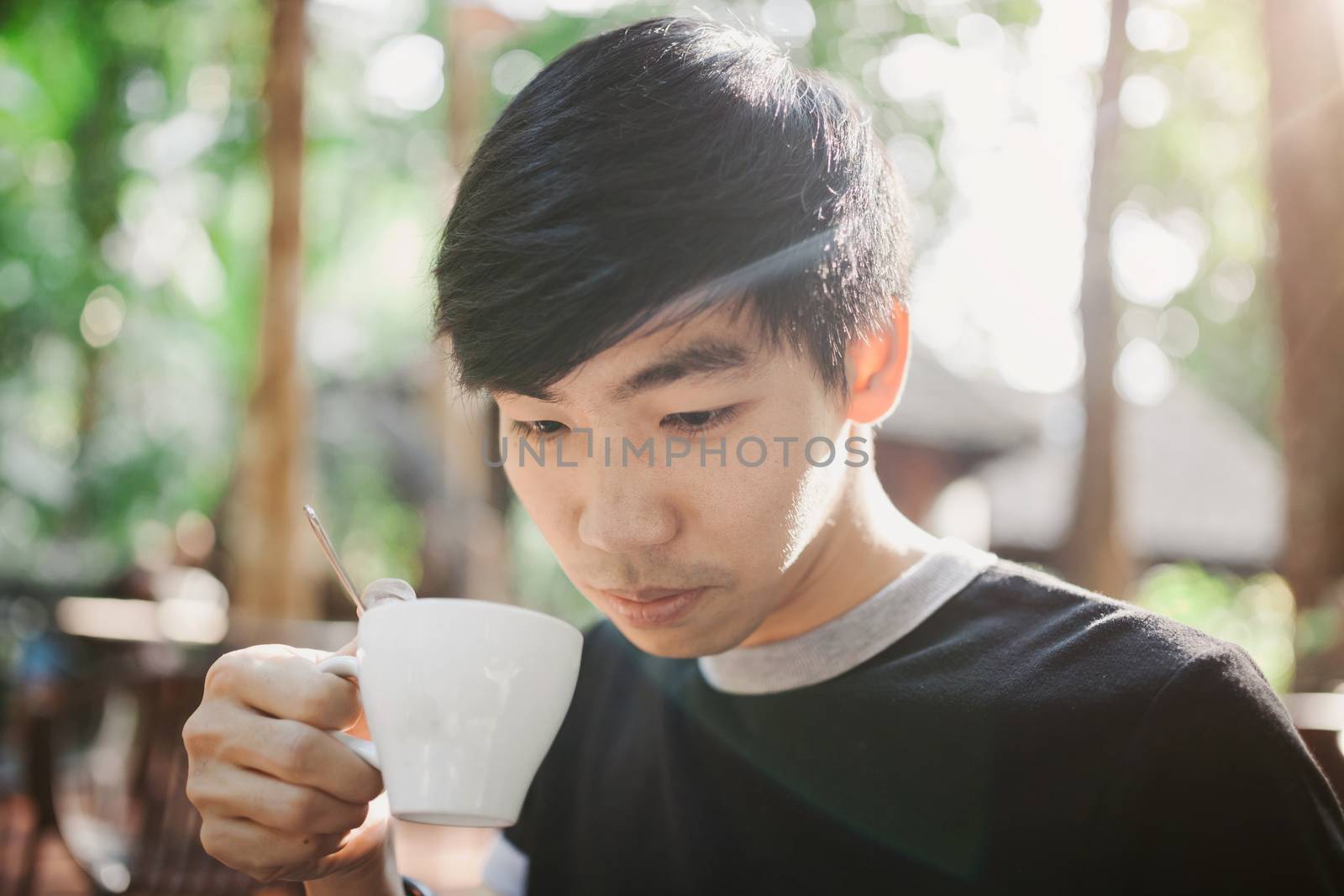 A man drinking on the morning coffee in sunshine light by nopparats
