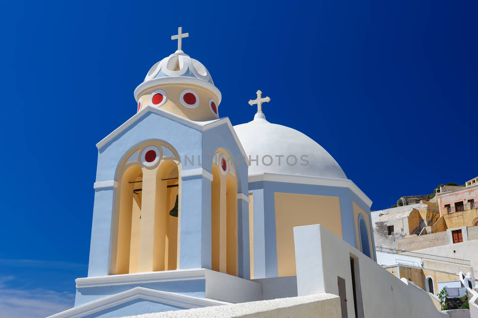 Blue, white and yellow orthodox church bell tower. Fira, Santorini Greece. Copyspace