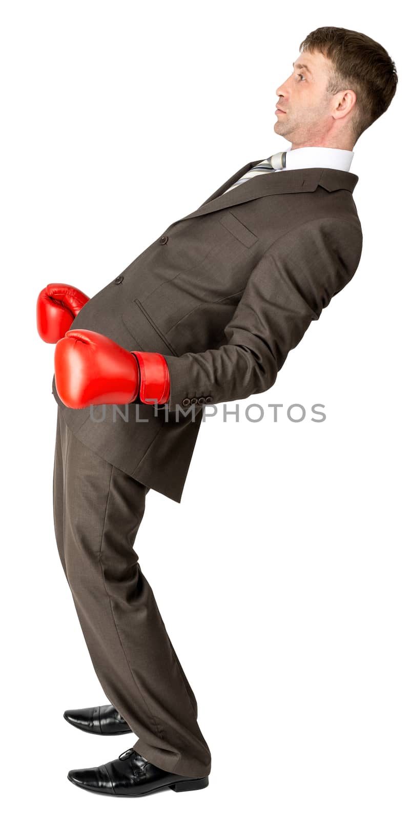 Businessman with boxing gloves defending against white background