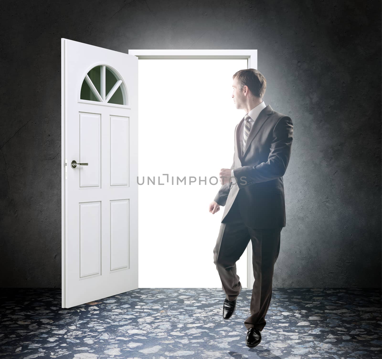 Image of young businessman standing with back opening door