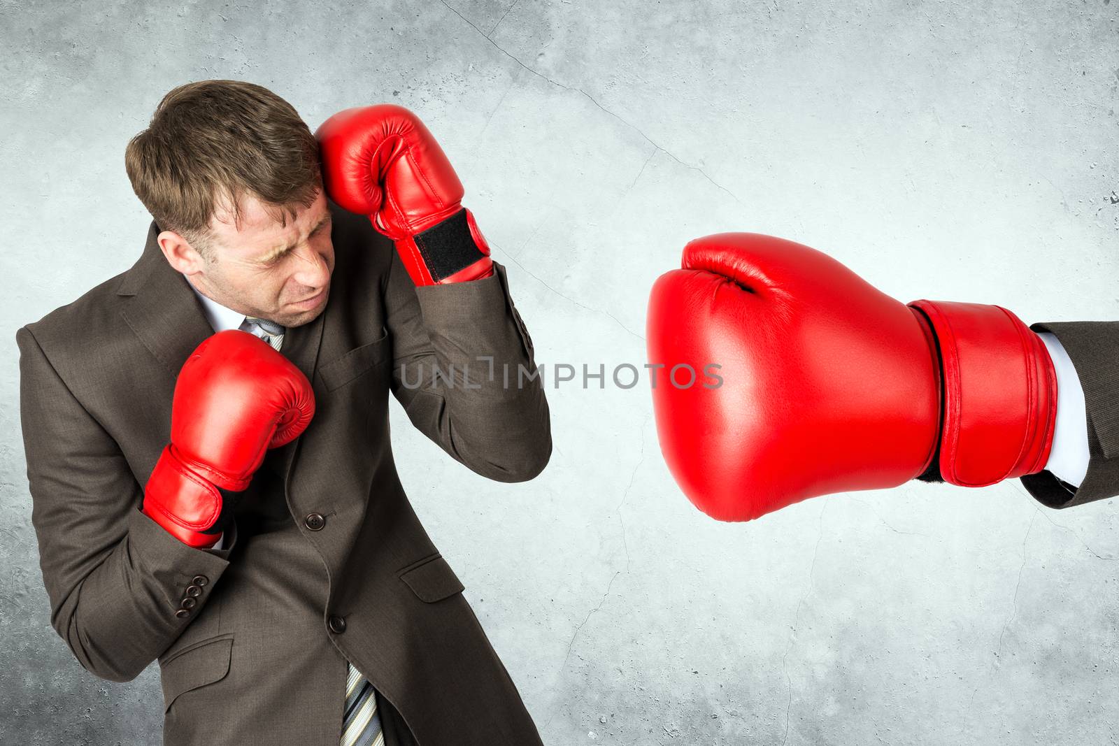Businessman in boxing gloves against big red boxing glove
