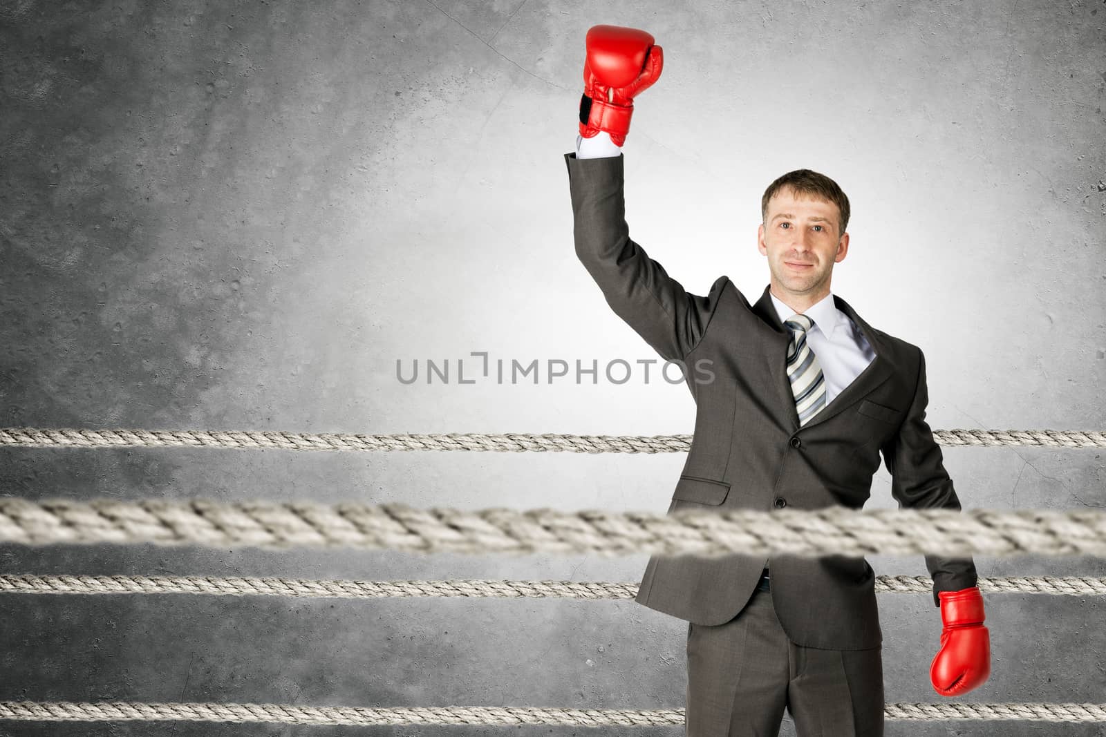 Portrait of a successful businessman on boxing ring