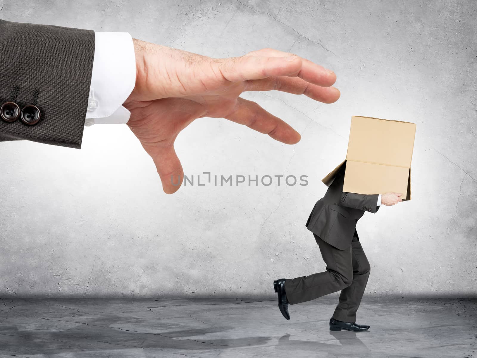 Business boss hand catching employee with box on his head