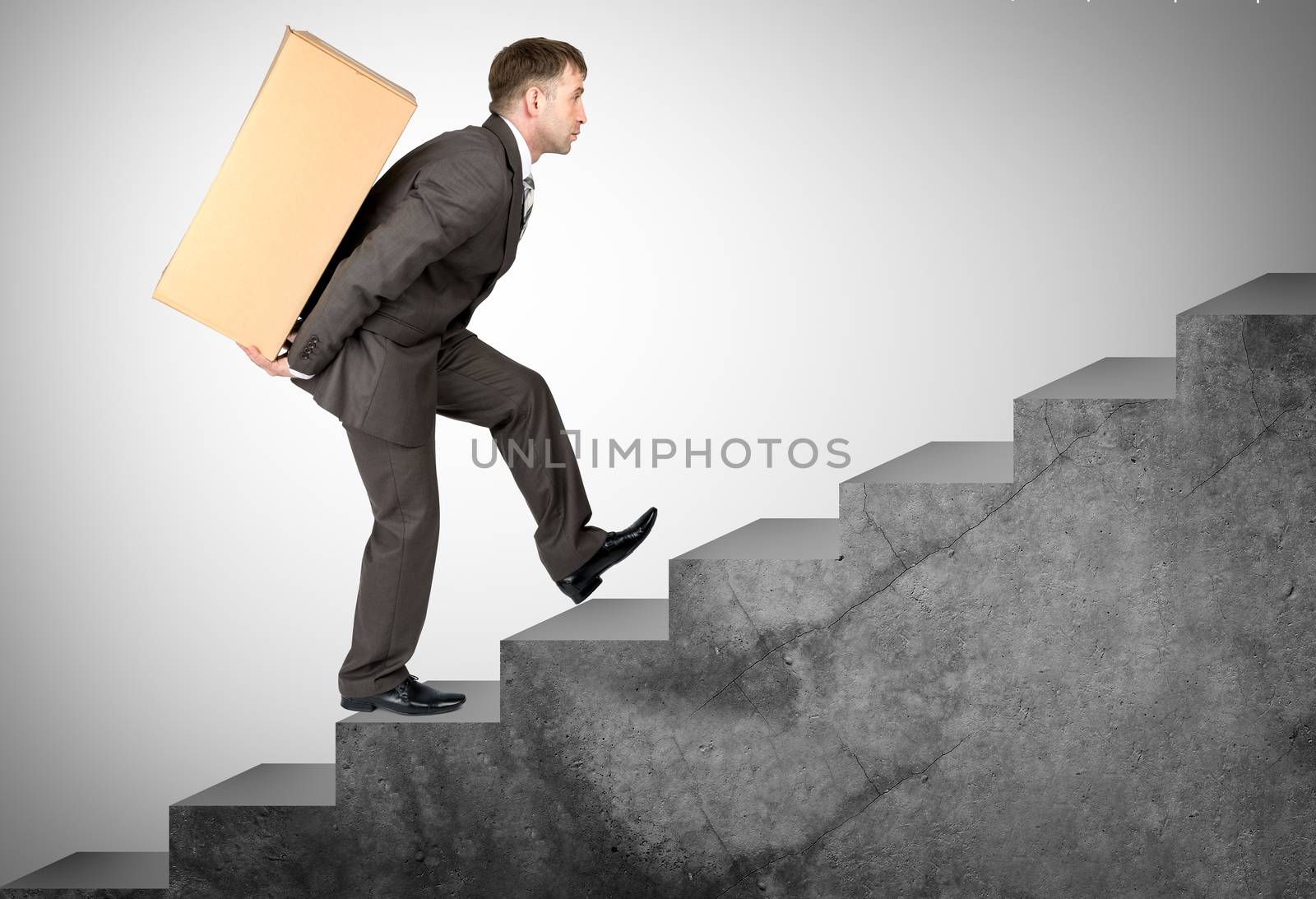 Middle aged business man with difficult task going up stairs