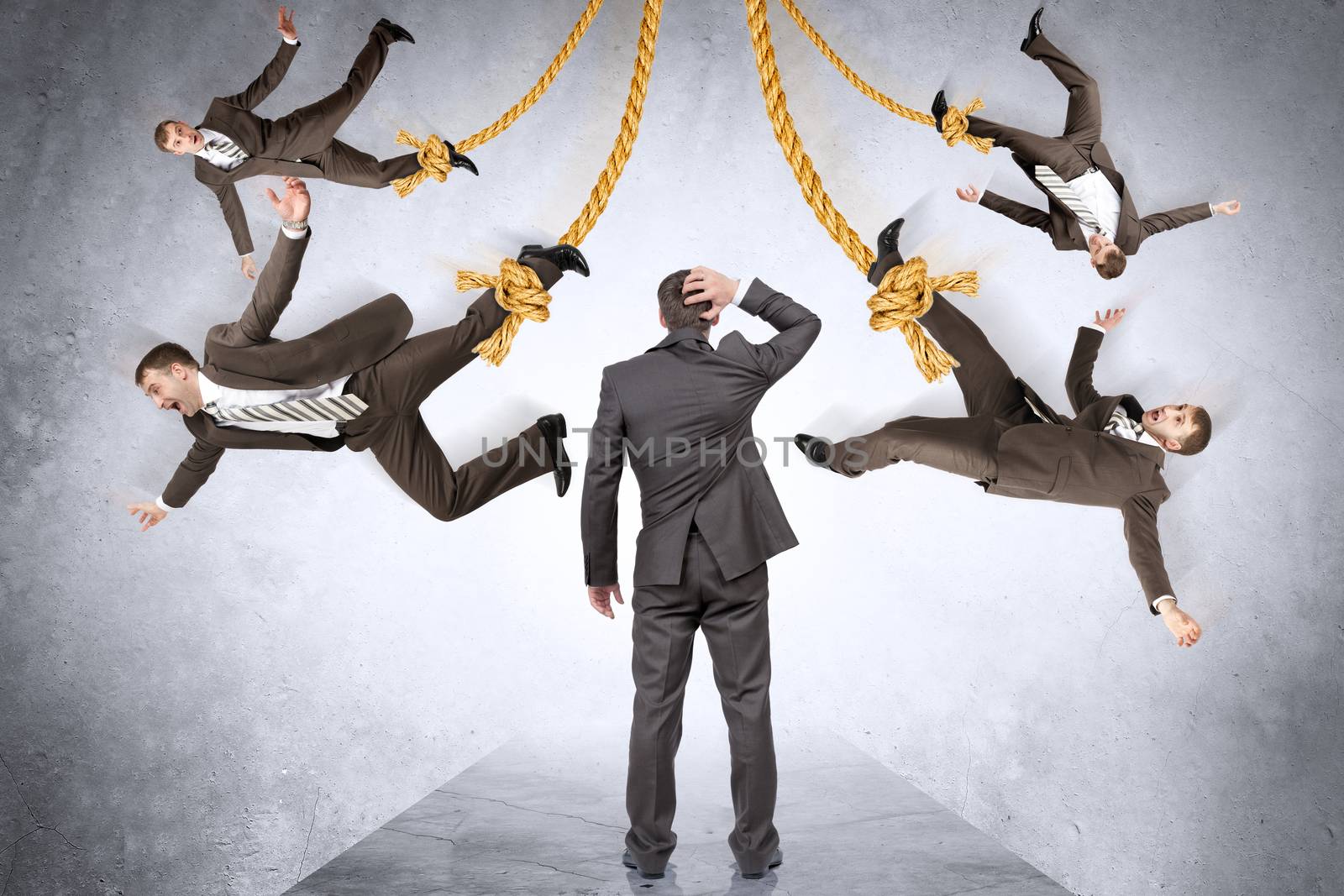 Confused businessman looking on hanging people by cherezoff