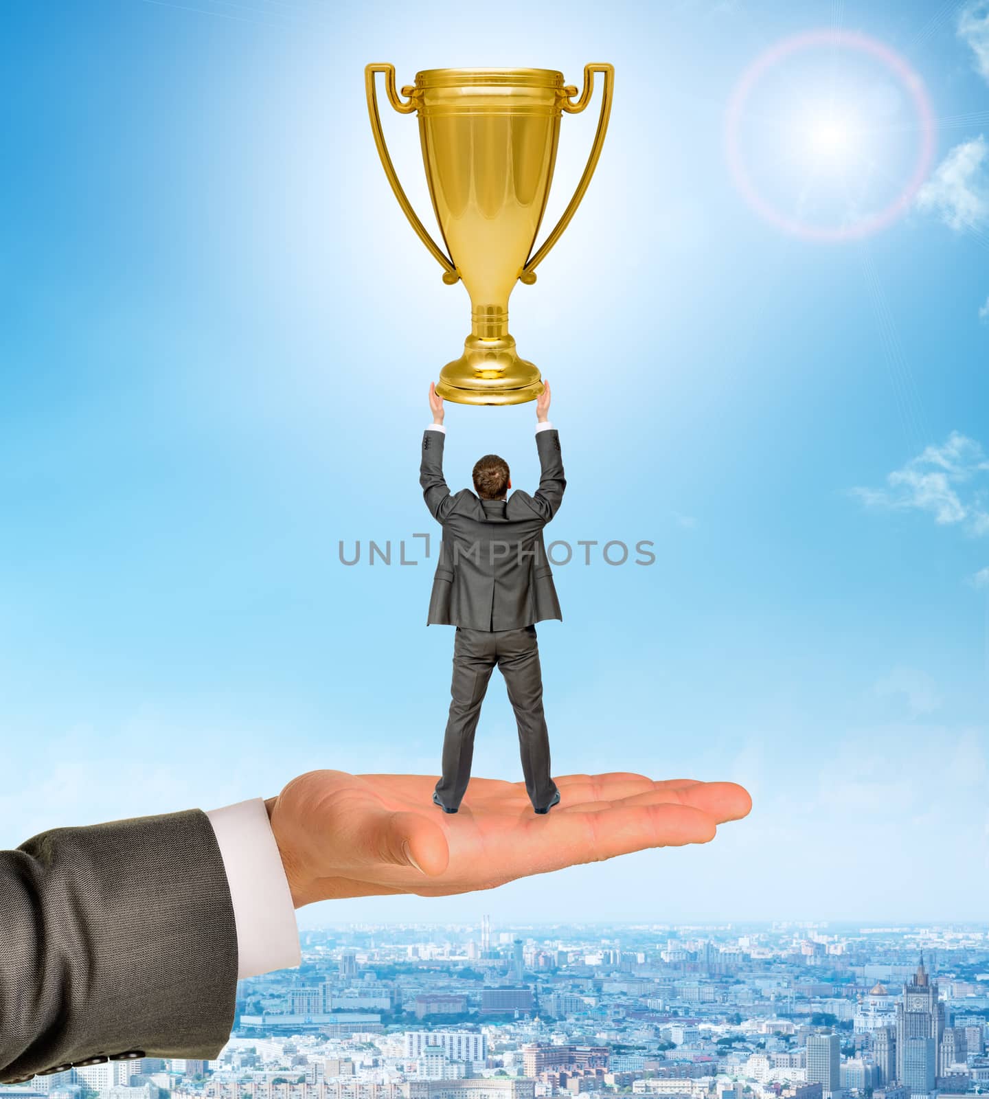 Businessman with cup on big hand by cherezoff