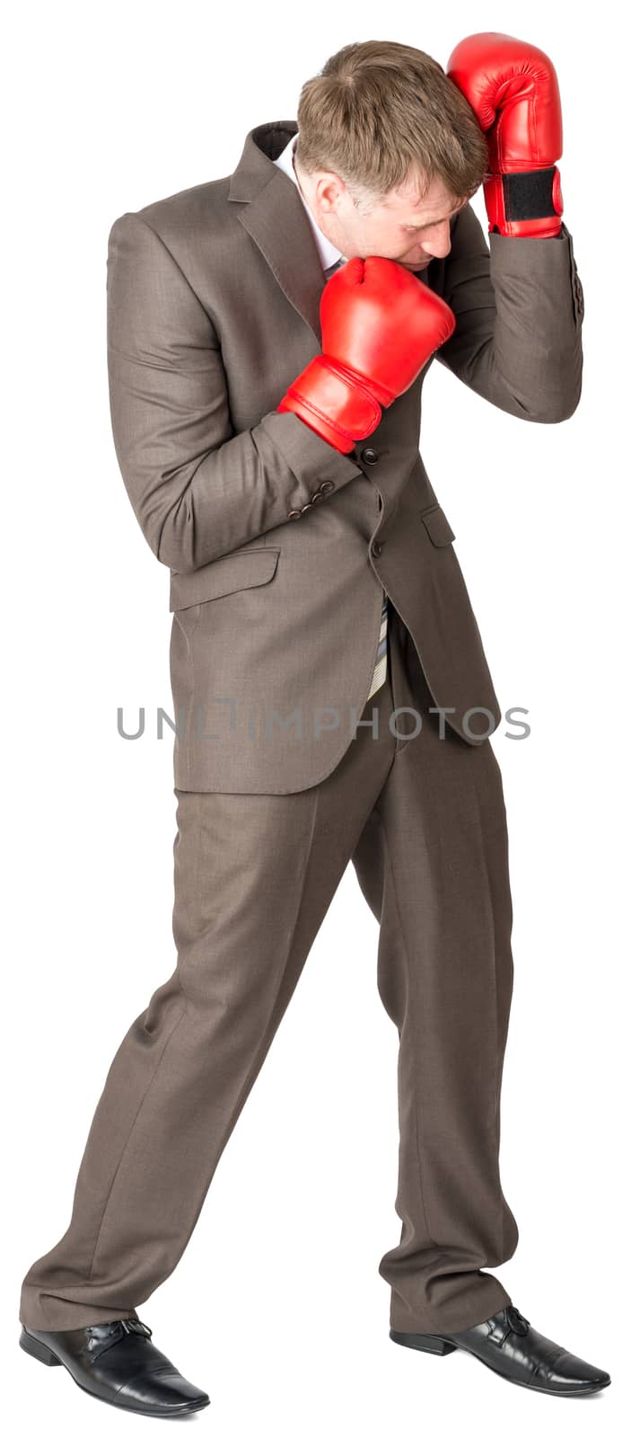 Businessman with boxing gloves defending by cherezoff