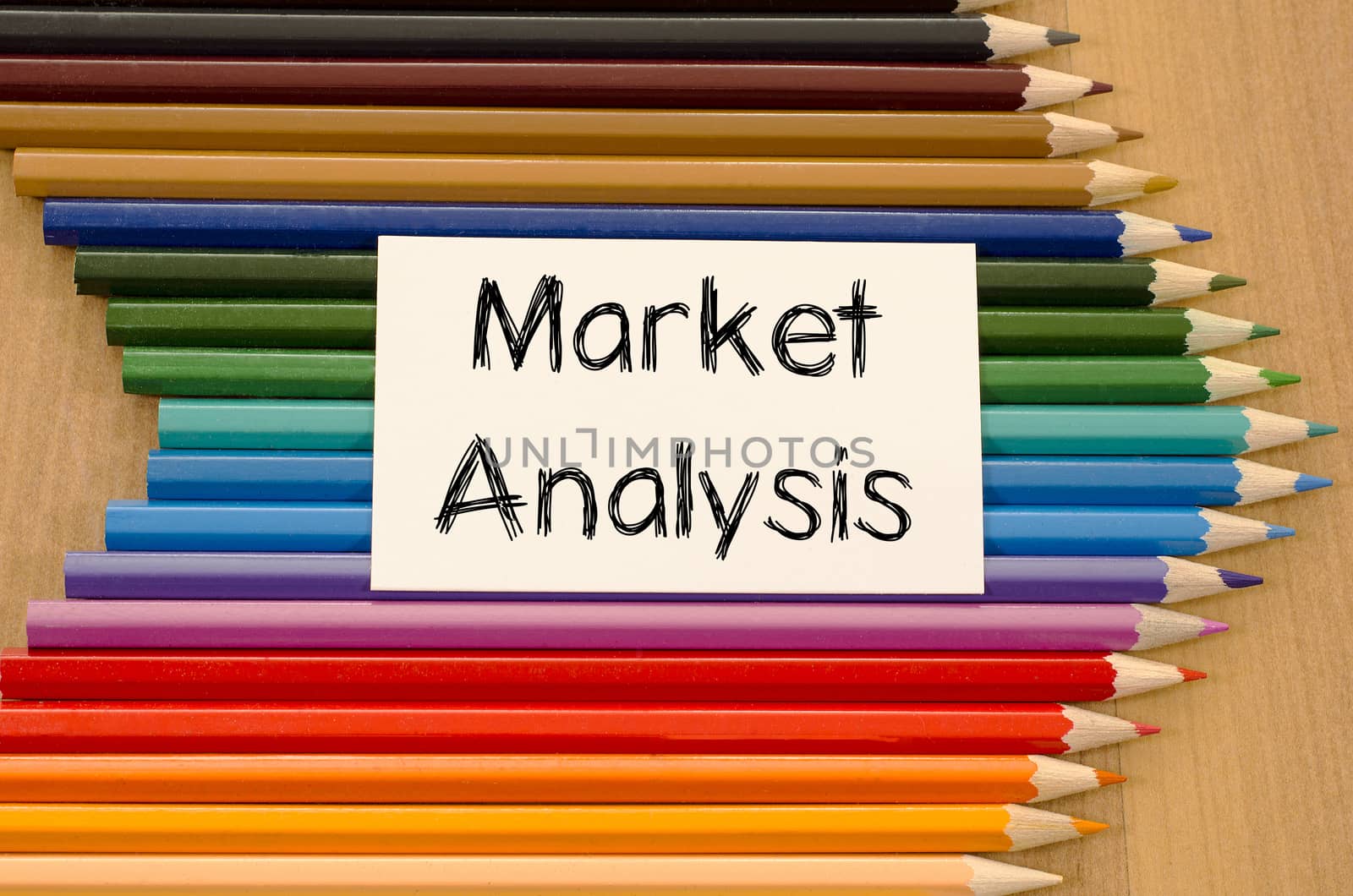 Market analysis text concept and colored pencil on wooden background