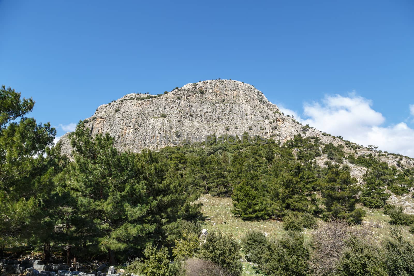 General temple view of Priene Ancient City in Aydın, Turkey, on bright blue sky background.