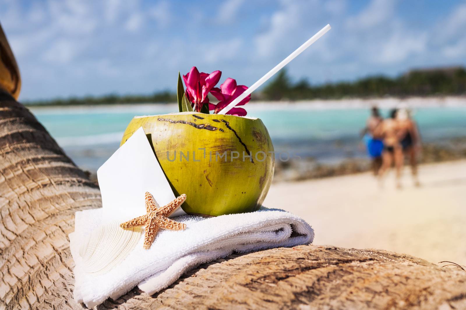 Coconut cocktail starfish tropical Caribbean beach refreshment and towel