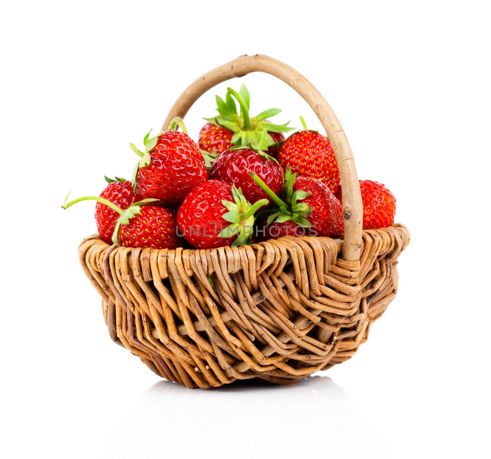 Strawberries in wicker basket, on white background