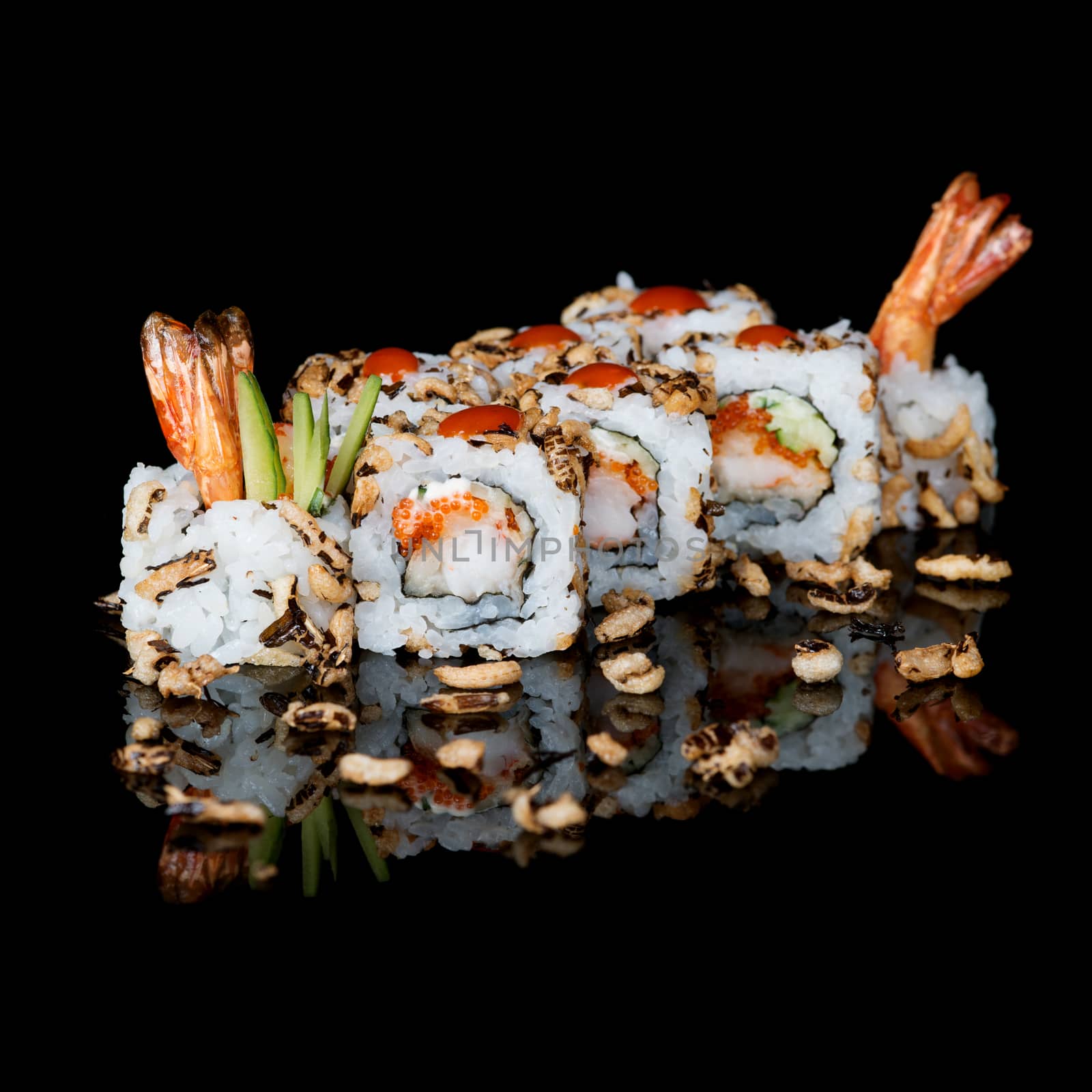 Sushi rolls with shrimps and cucumber on  black background