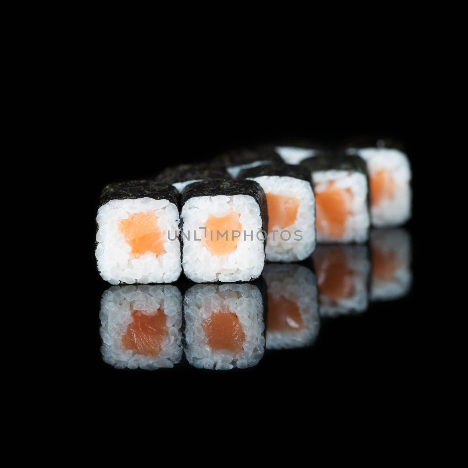 Sushi rolls with salmon on  black background