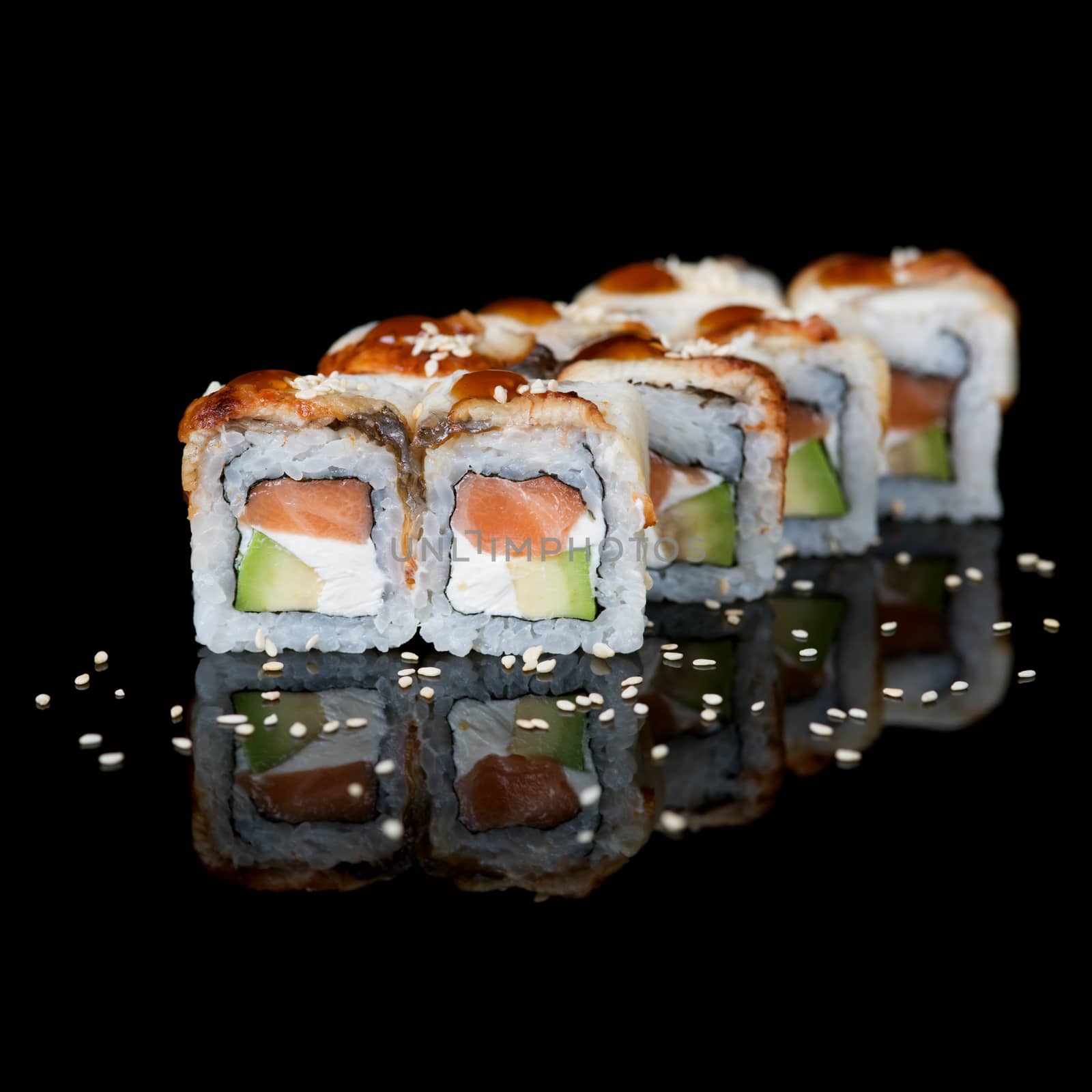 Sushi rolls with eel and salmon on  black background