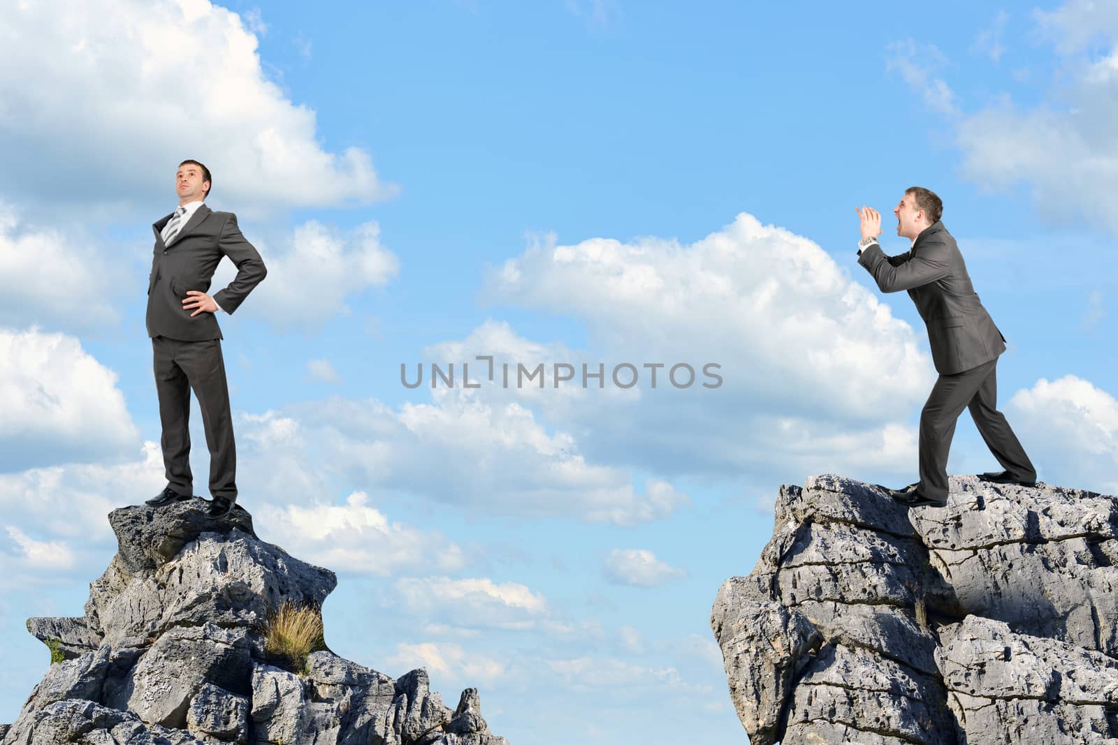 Businessman screaming and standing on the mountain by cherezoff