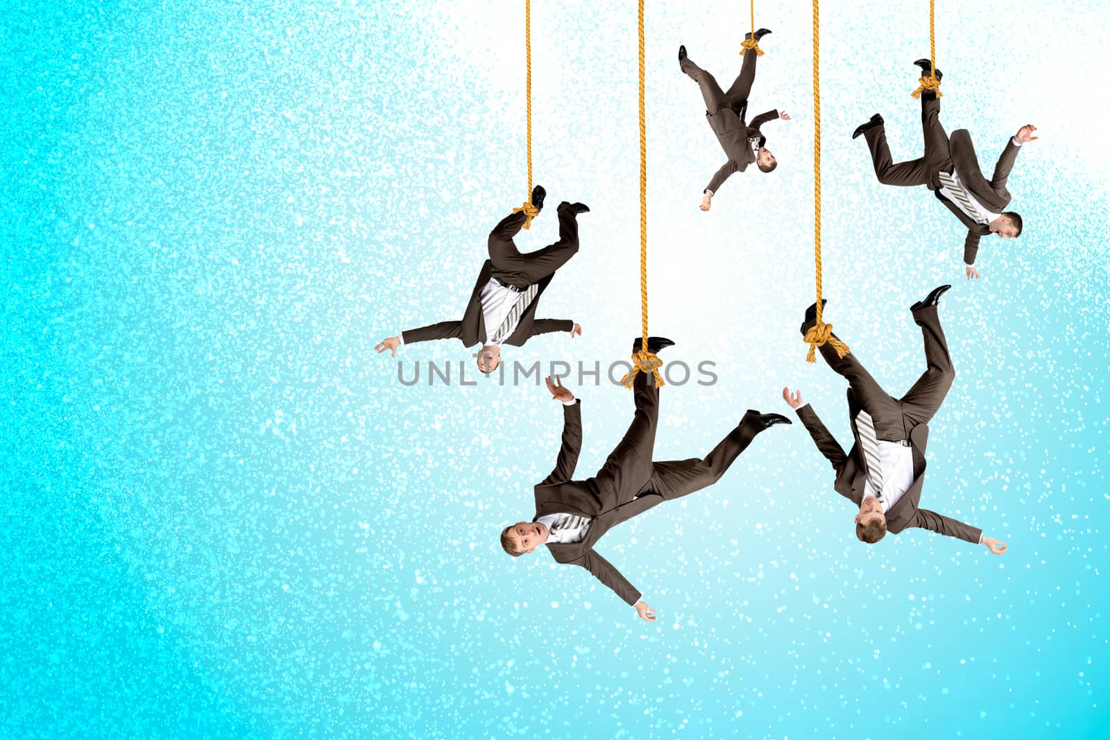 Businessmen hanging on ropes, place image of your product underneath them