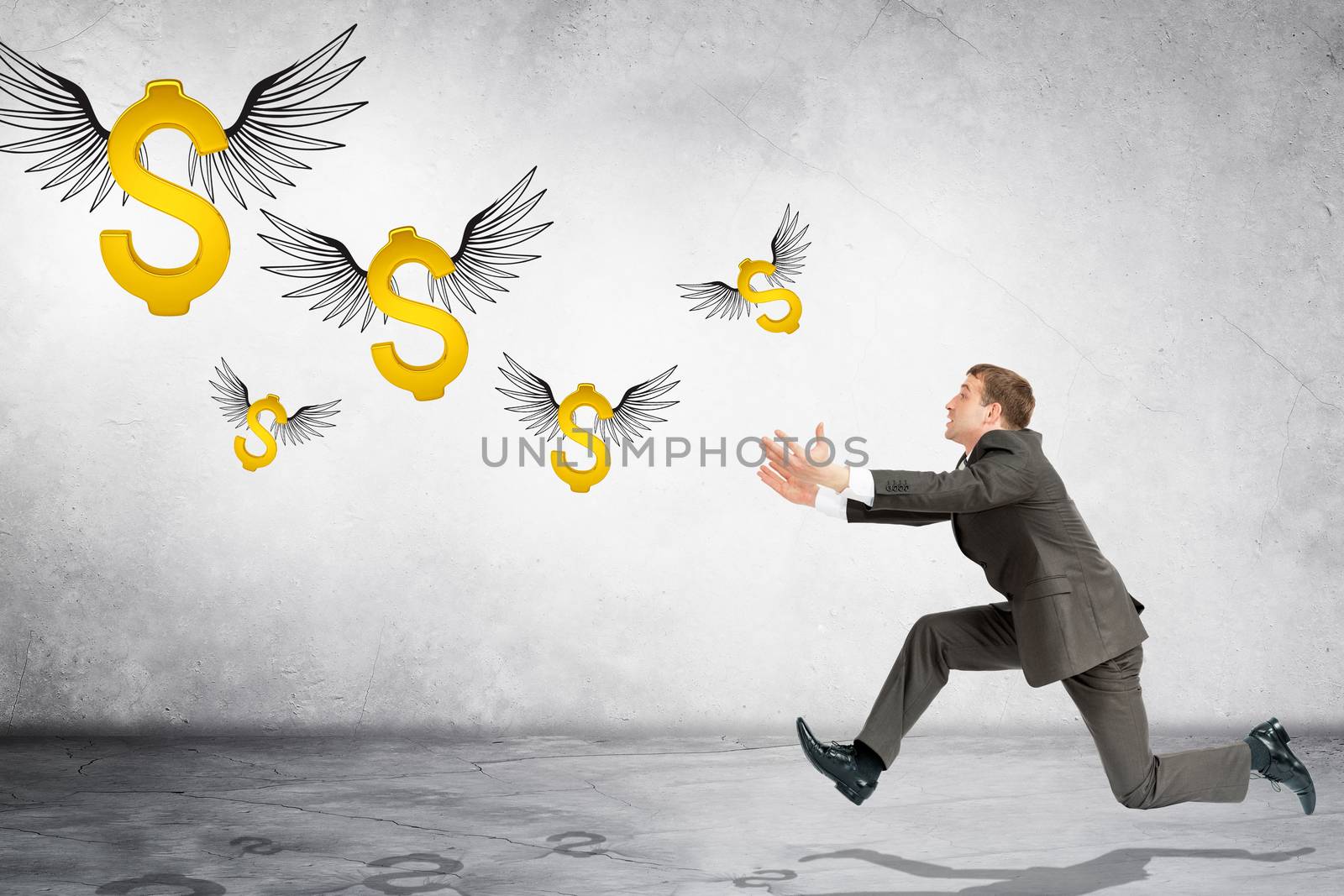 Business man running to catch flying dollar sign on gray background