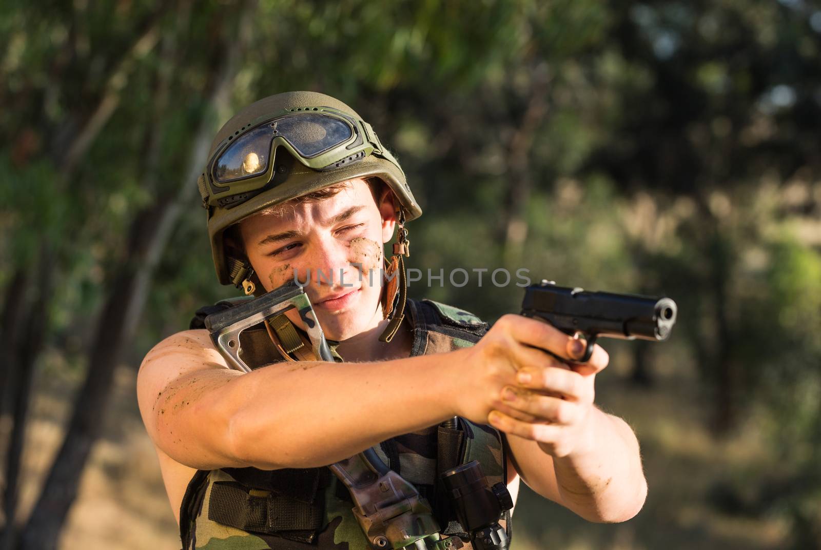 young a soldier in the uniform with weapon