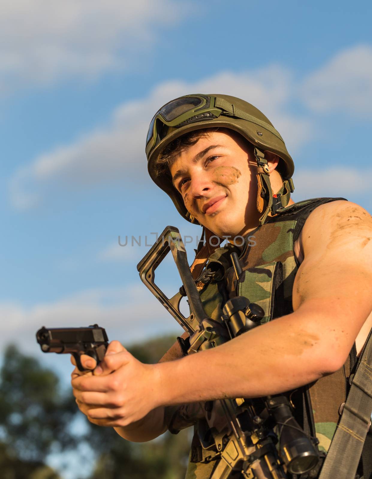 young a soldier in the uniform with weapon