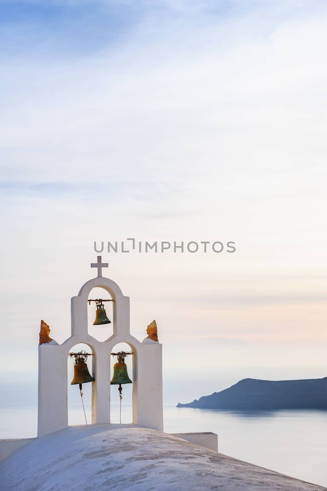 Orthodox church bell tower. Imegovigli village, Santorini Greece. Copyspace