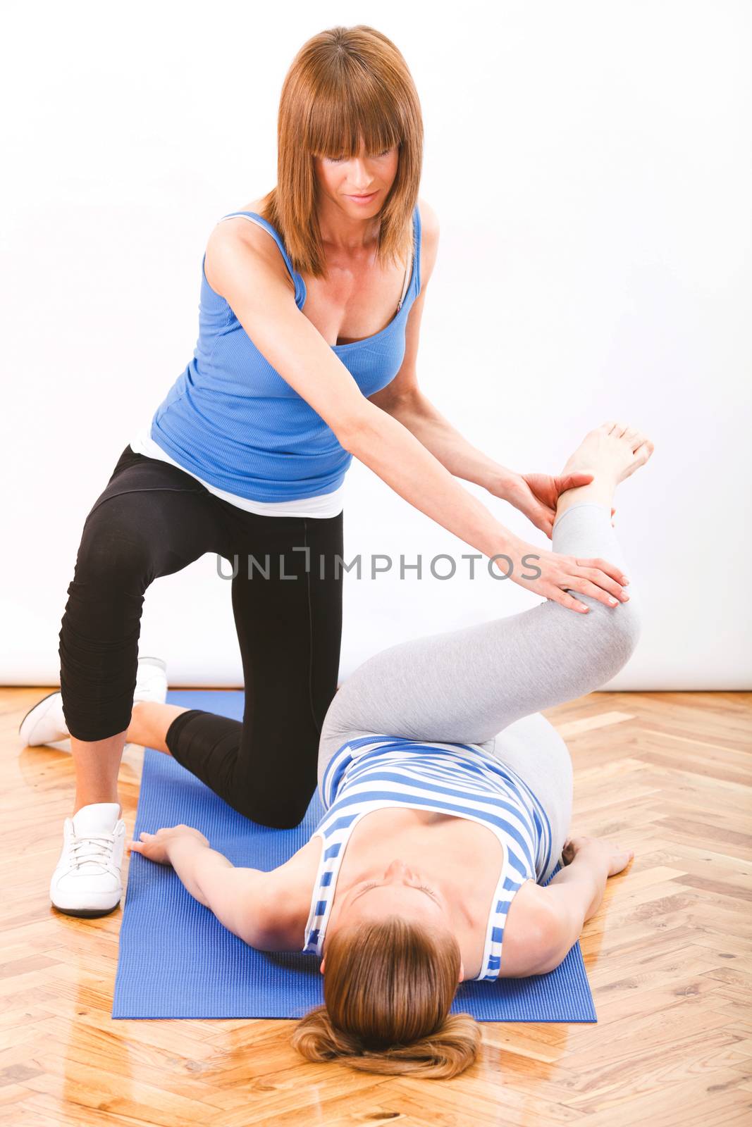 young woman stretching With a fitness instructor