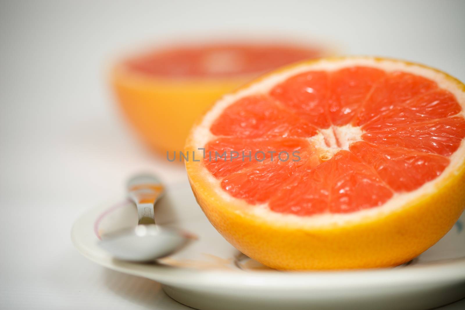 Halved red grapefruit on plate
