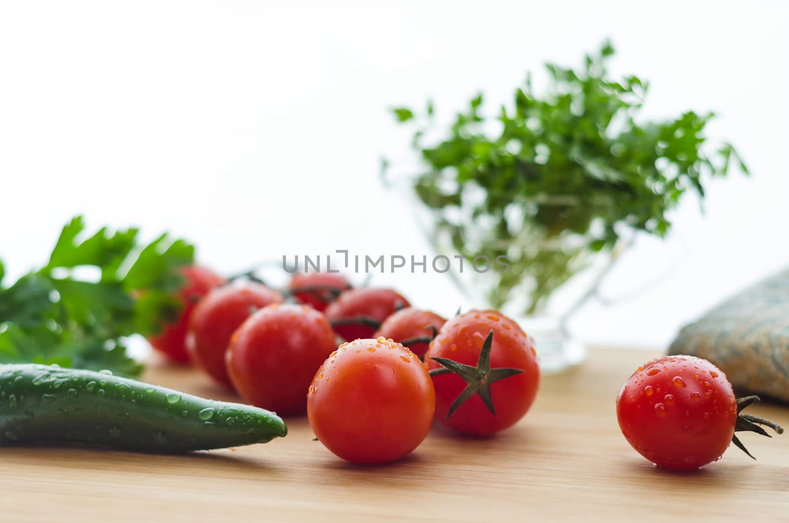 Tomatoes and cucumbers on a wooden surface, natural light, bokeh. by Gaina