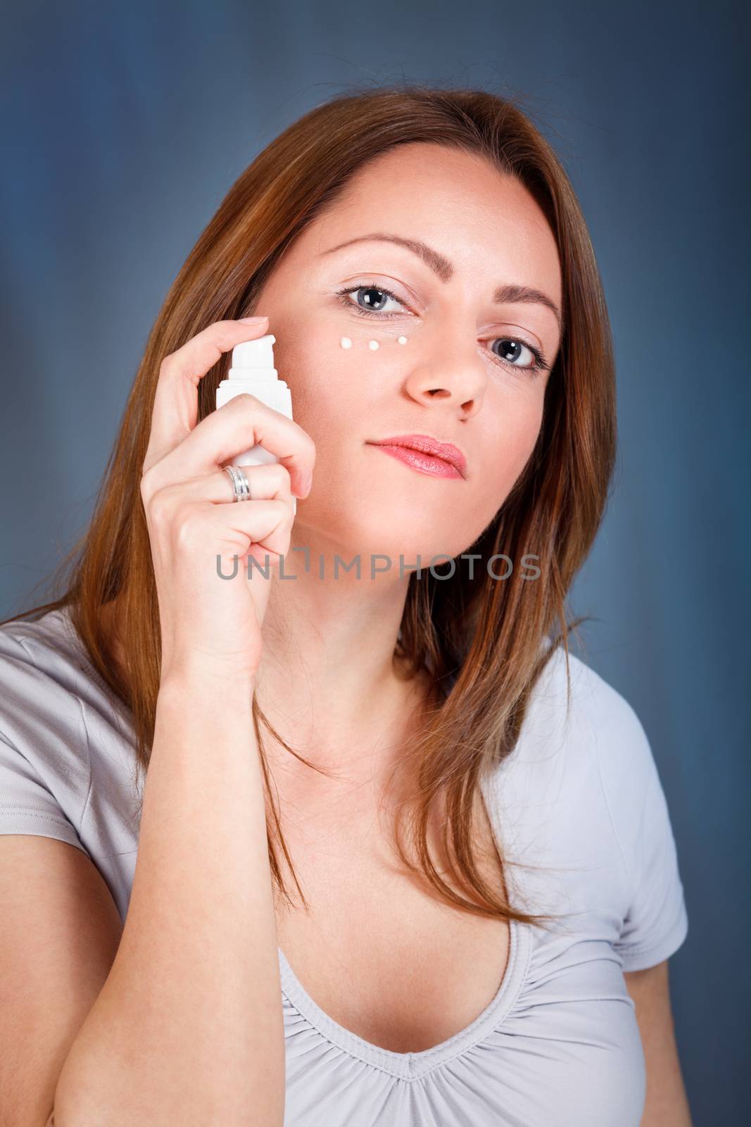 Young woman applied anti-wrinkle cream