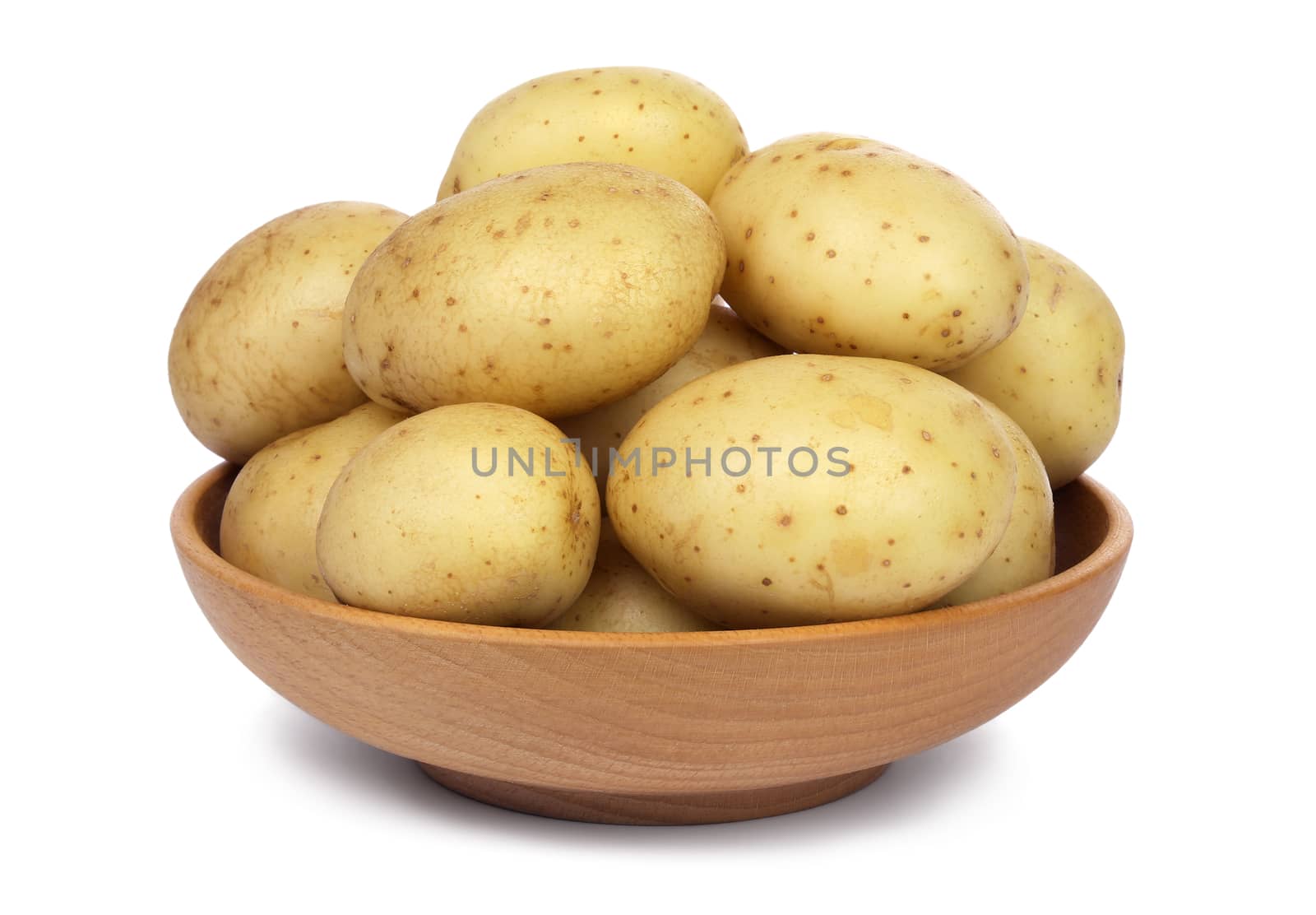 Raw unpeeled potatoes in a wooden bowl, isolated on white background.