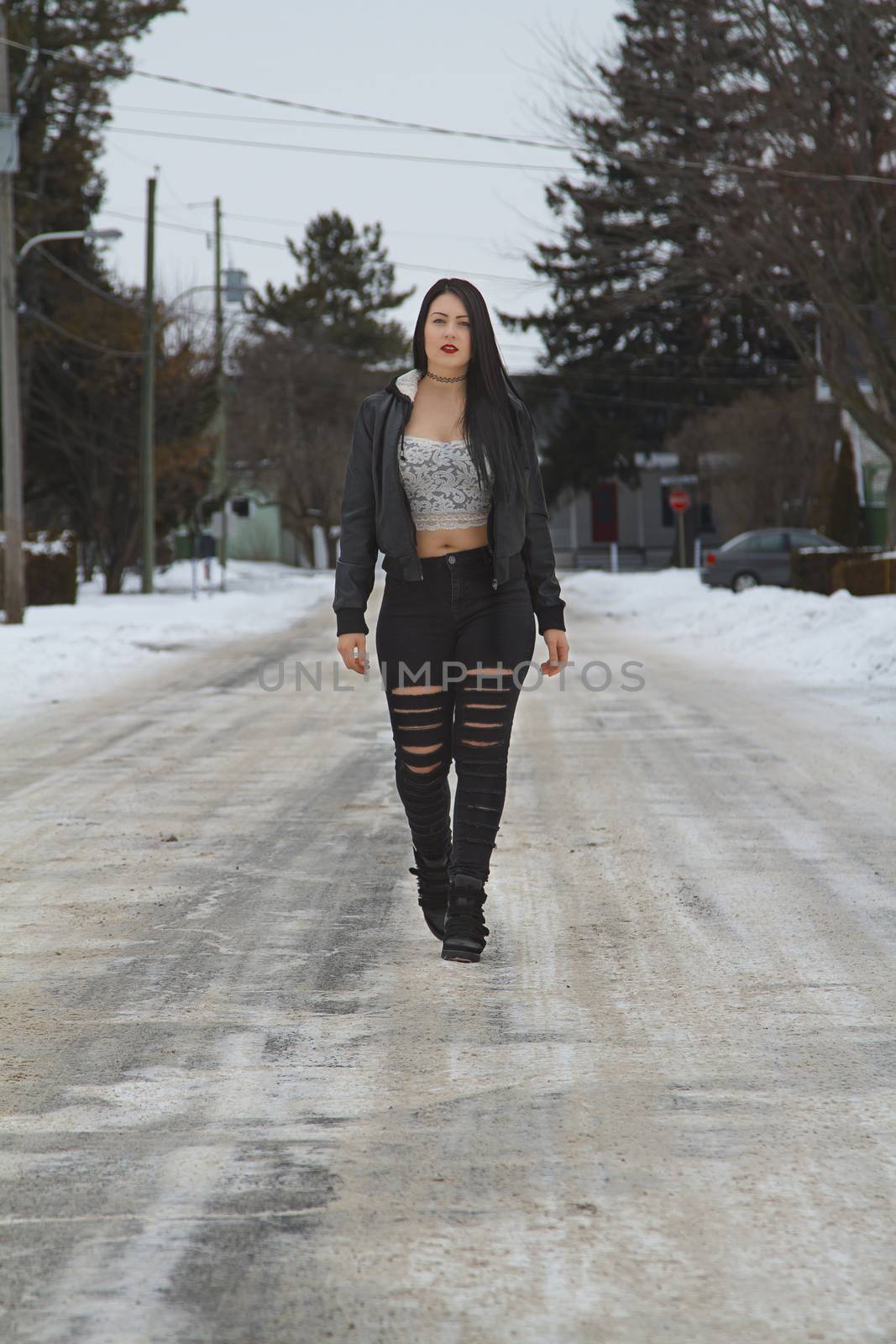 young, sexy, woman walking down the street during winter